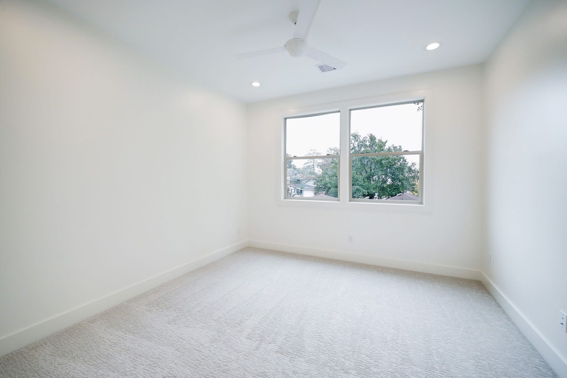 Secondary Bedroom #2 features large windows, ceiling fan, and a neutral color palette. *Previous Project*