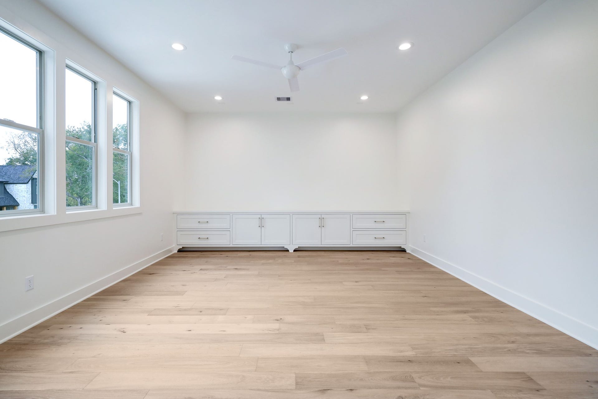 The game room is situated at the heart of the second floor. The abundance of natural light through the windows creates a natural transition on the second floor. Built-in cabinetry offers space for gaming systems, toys and A/V equipment. *Previous Project*