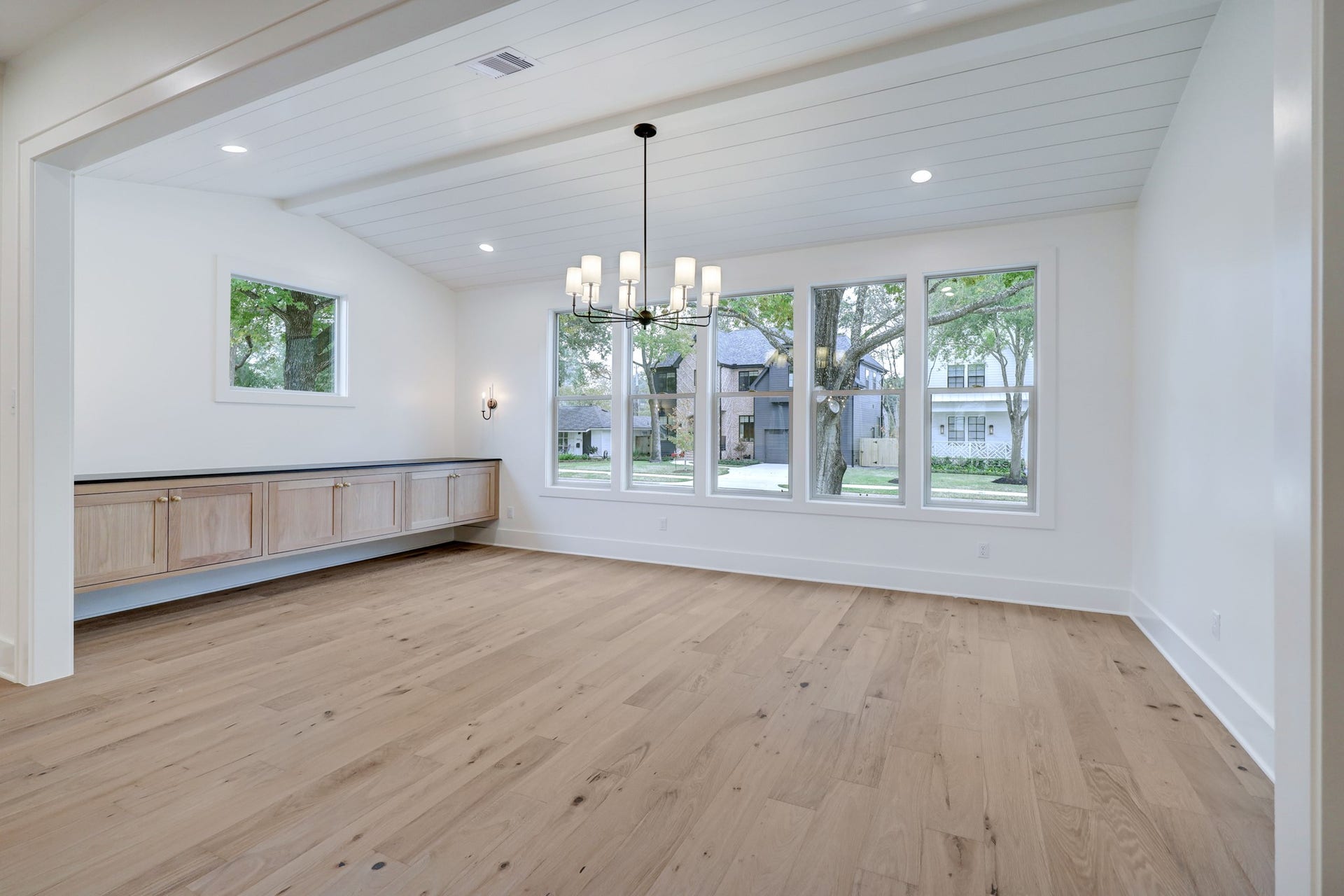 The dining room sits at the front of the home, just off the kitchen, providing a great space for entertaining friends and family. Thoughtful window placement allows natural light to cascade throughout the room while keeping privacy in mind. Built-in floating cabinetry creates a space for storage. *Previous Project*
