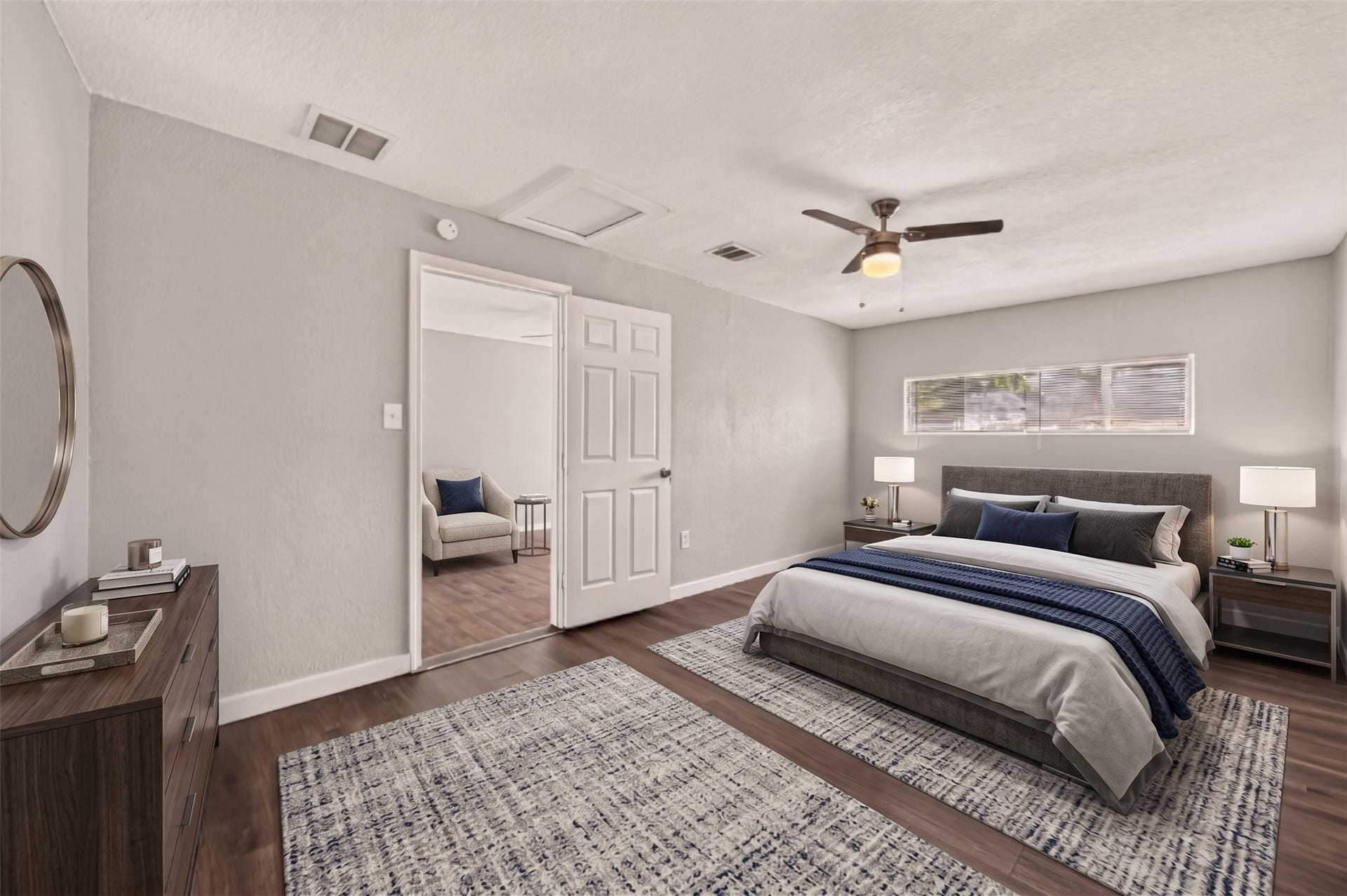 5935 Beldart Street, Houston, TX 77033 Primary bedroom with ceiling fan, clerestory window, and door to the en-suite bath. (Virtually staged)