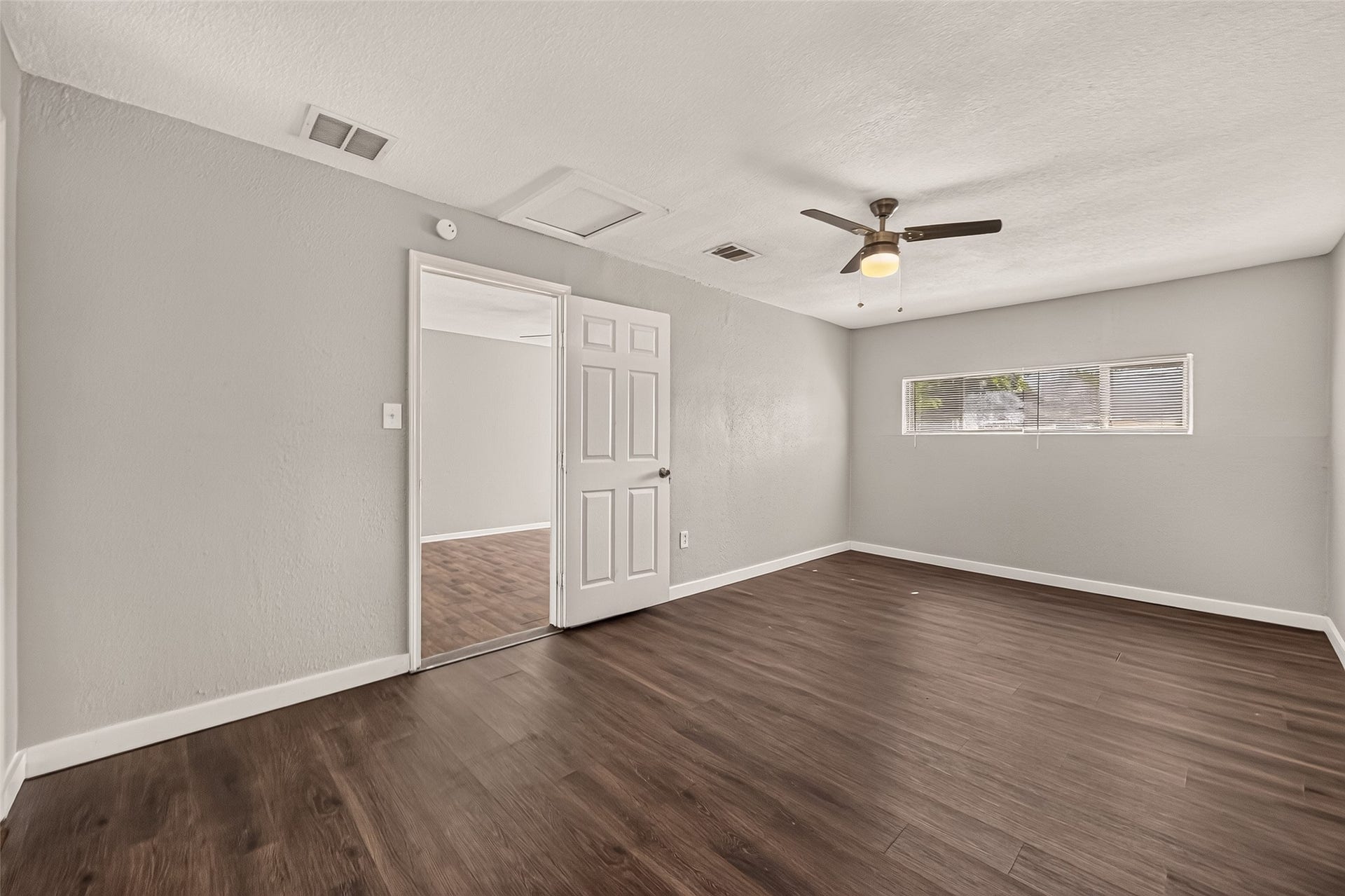 5935 Beldart Street, Houston, TX 77033 Primary bedroom, unfurnished, with ceiling fan and clerestory window.