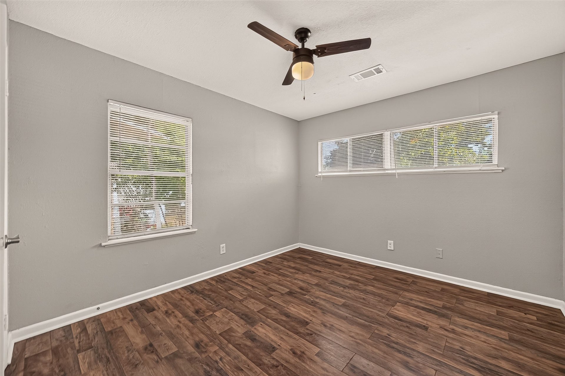 5935 Beldart Street, Houston, TX 77033 Bedroom 4, unfurnished, with two windows and ceiling fan.