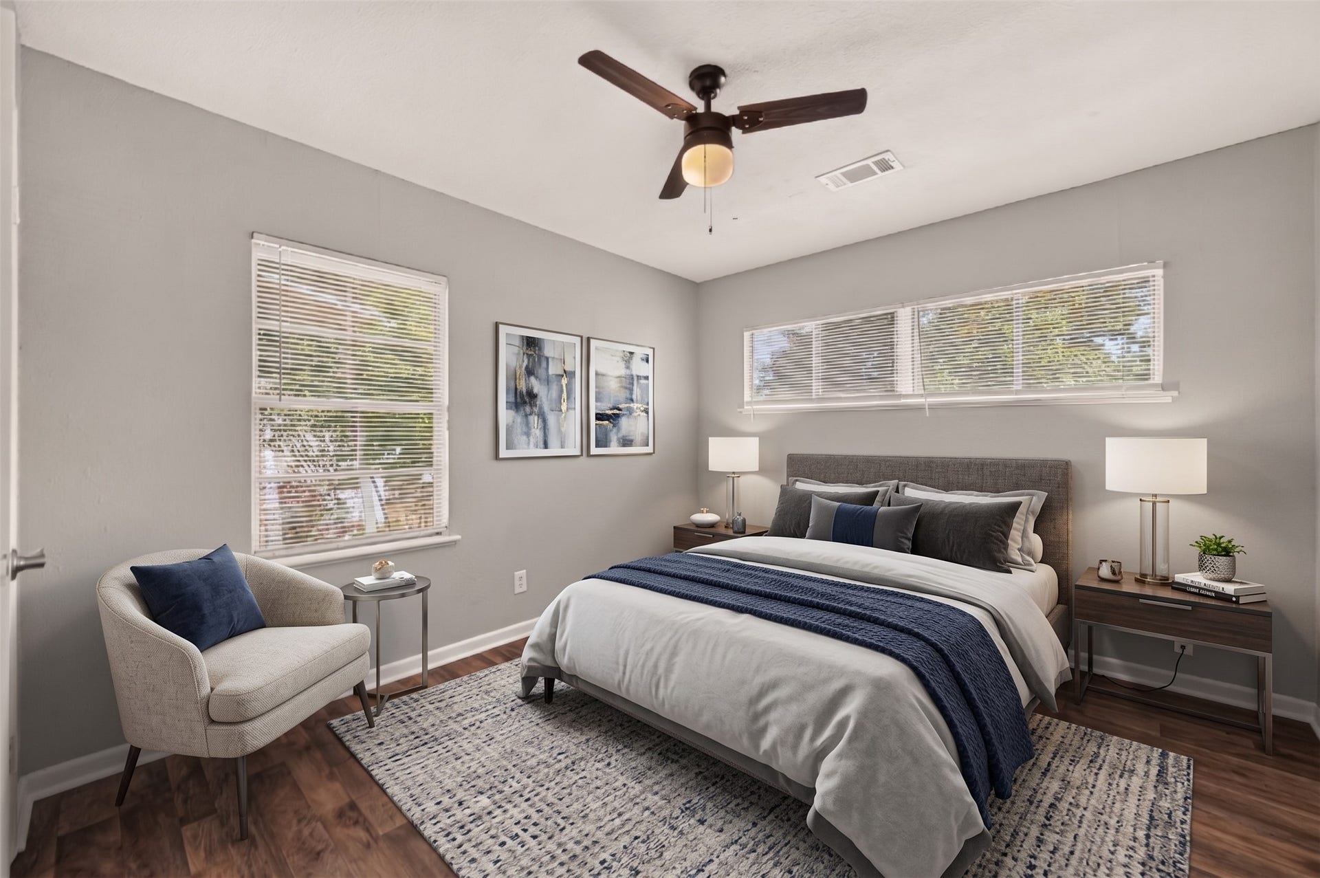 5935 Beldart Street, Houston, TX 77033 Bedroom 4 with two windows and ceiling fan. (Virtually staged)