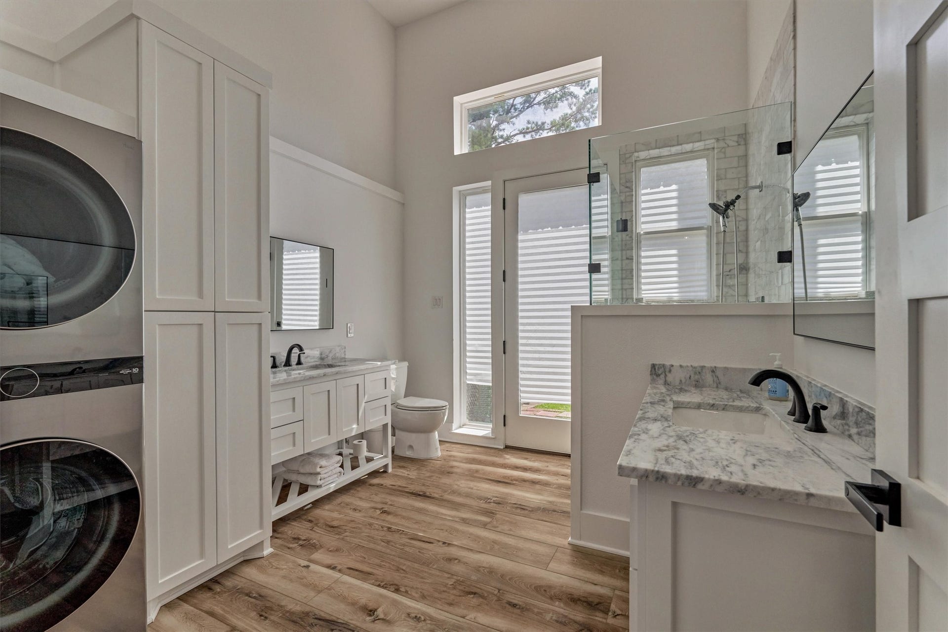 9228 Lake Conroe Drive, Conroe, TX 77304 A third full bath off of the game room features a walk-in shower, two vanity areas, washer and dryer hook ups and plenty of storage. This exterior door leads to a side yard/ dog run.