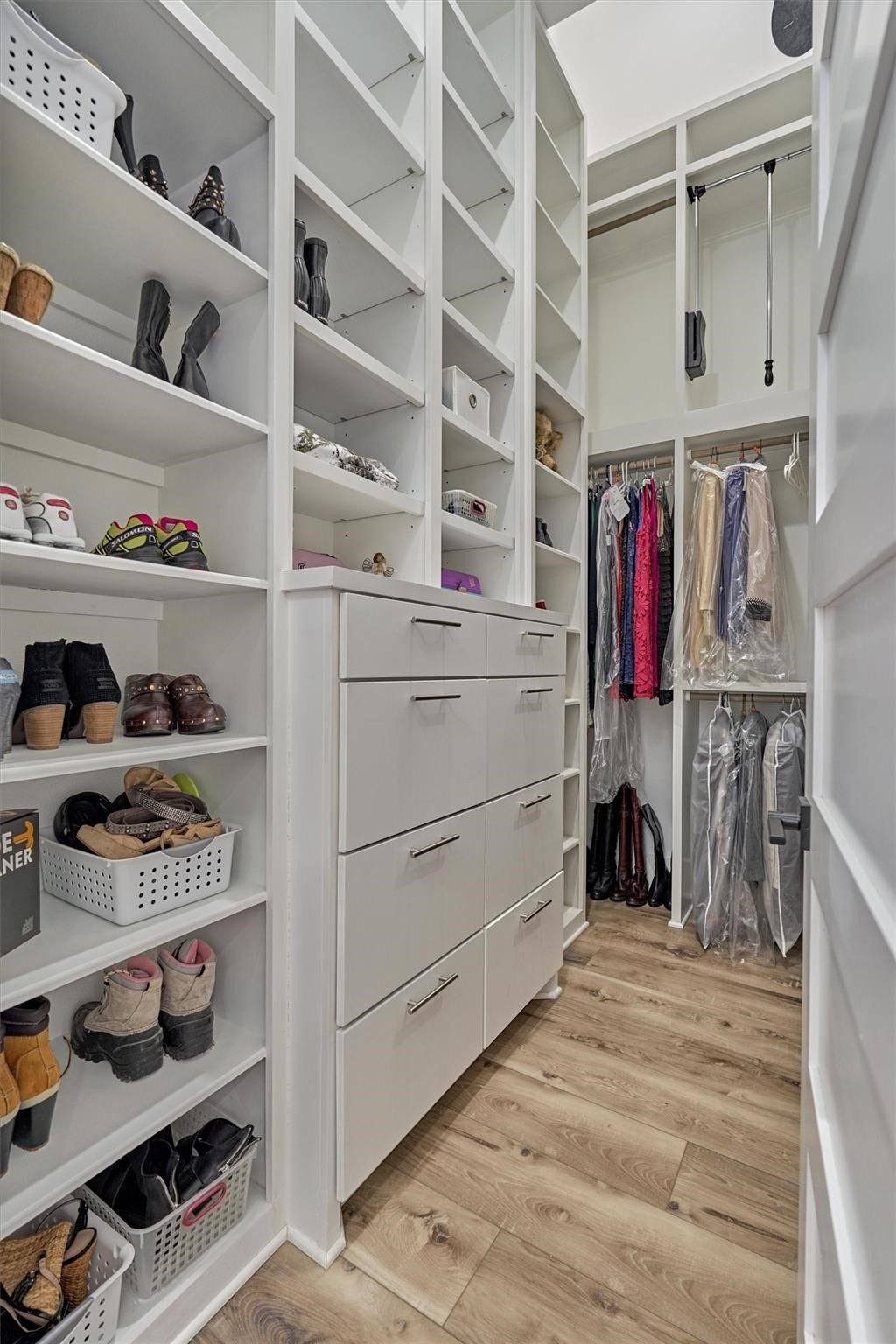 9228 Lake Conroe Drive, Conroe, TX 77304 One of the two primary closets is equipped with built-in cabinetry that reaches the ceiling, along with convenient pull down hanging racks for easy access to the top level. Around the corner, you'll find space for a full size washer and dryer.