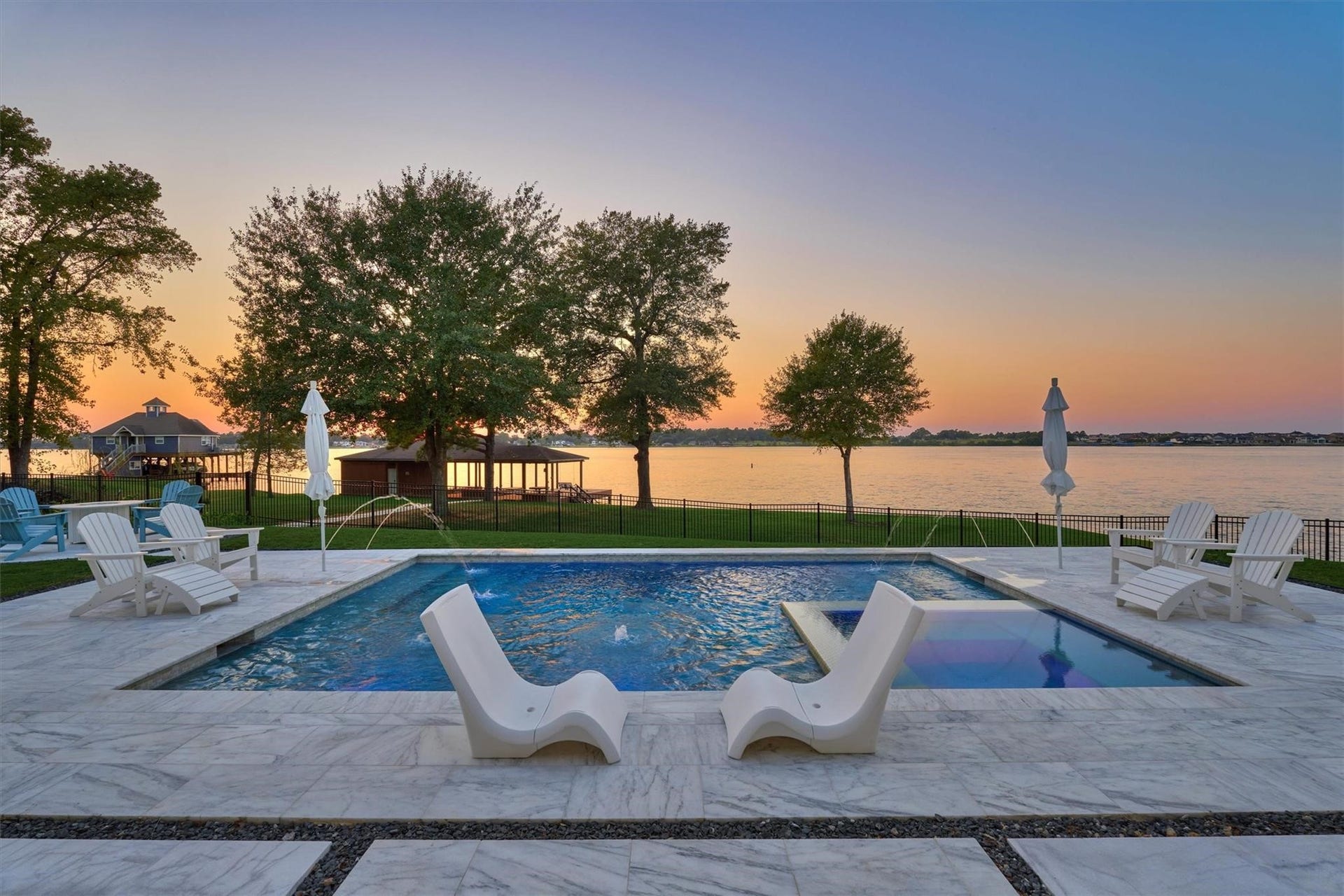 9228 Lake Conroe Drive, Conroe, TX 77304 A heated chlorine pool and hot tub overlook the lake for unmatched sunset views.