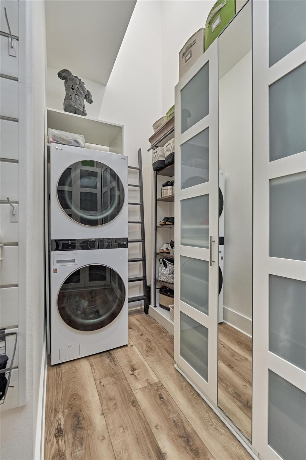 9228 Lake Conroe Drive, Conroe, TX 77304 The second primary closet has custom cabinetry and space for its own full size washer and dryer. Featuring frosted glass and mirrored doors, this closet offers a sleek and clean look while maintaining functionality and style.