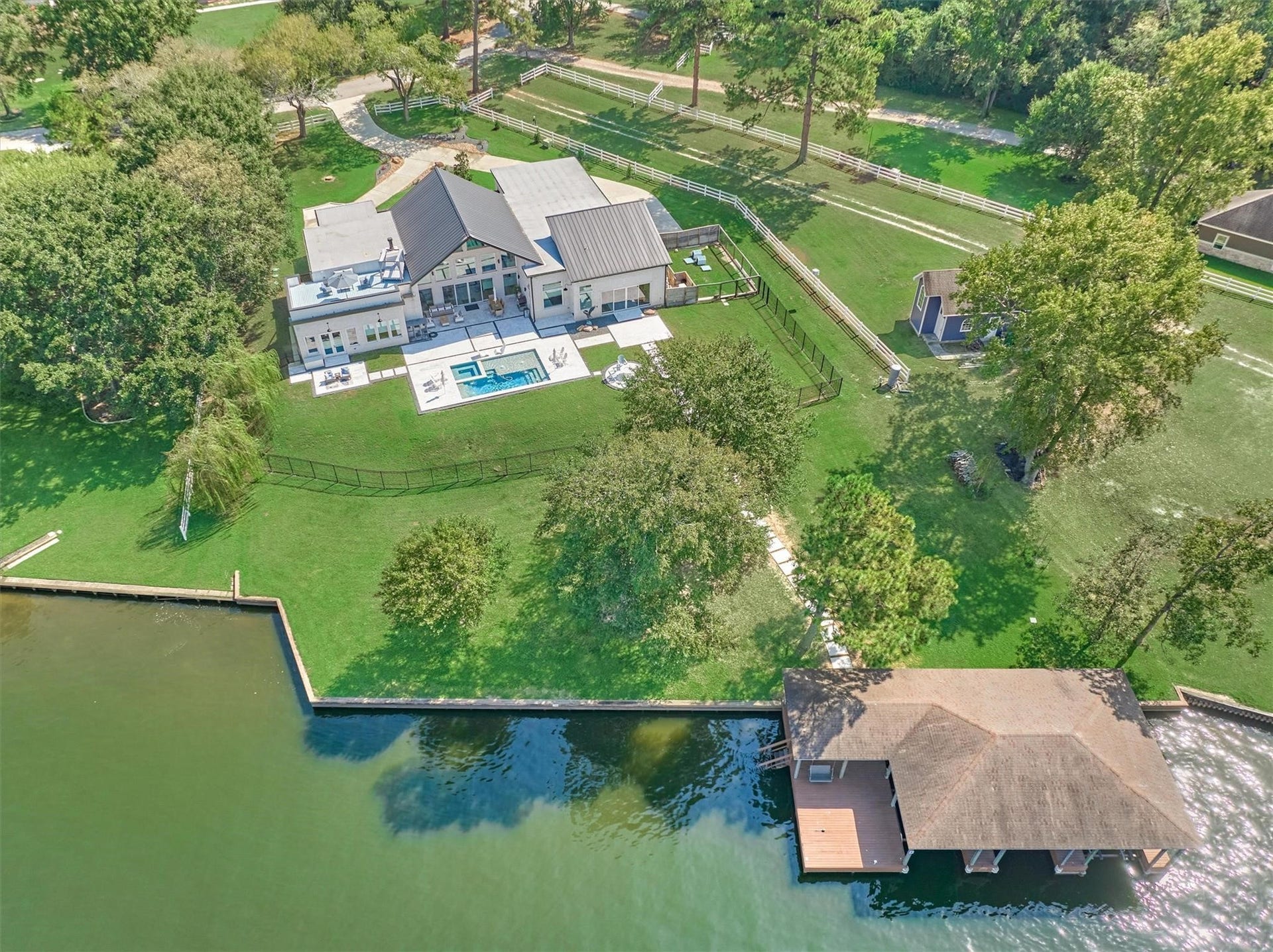 9228 Lake Conroe Drive, Conroe, TX 77304 49. This aerial view highlights the entire property, showcasing its expansive layout and the privacy it provides.