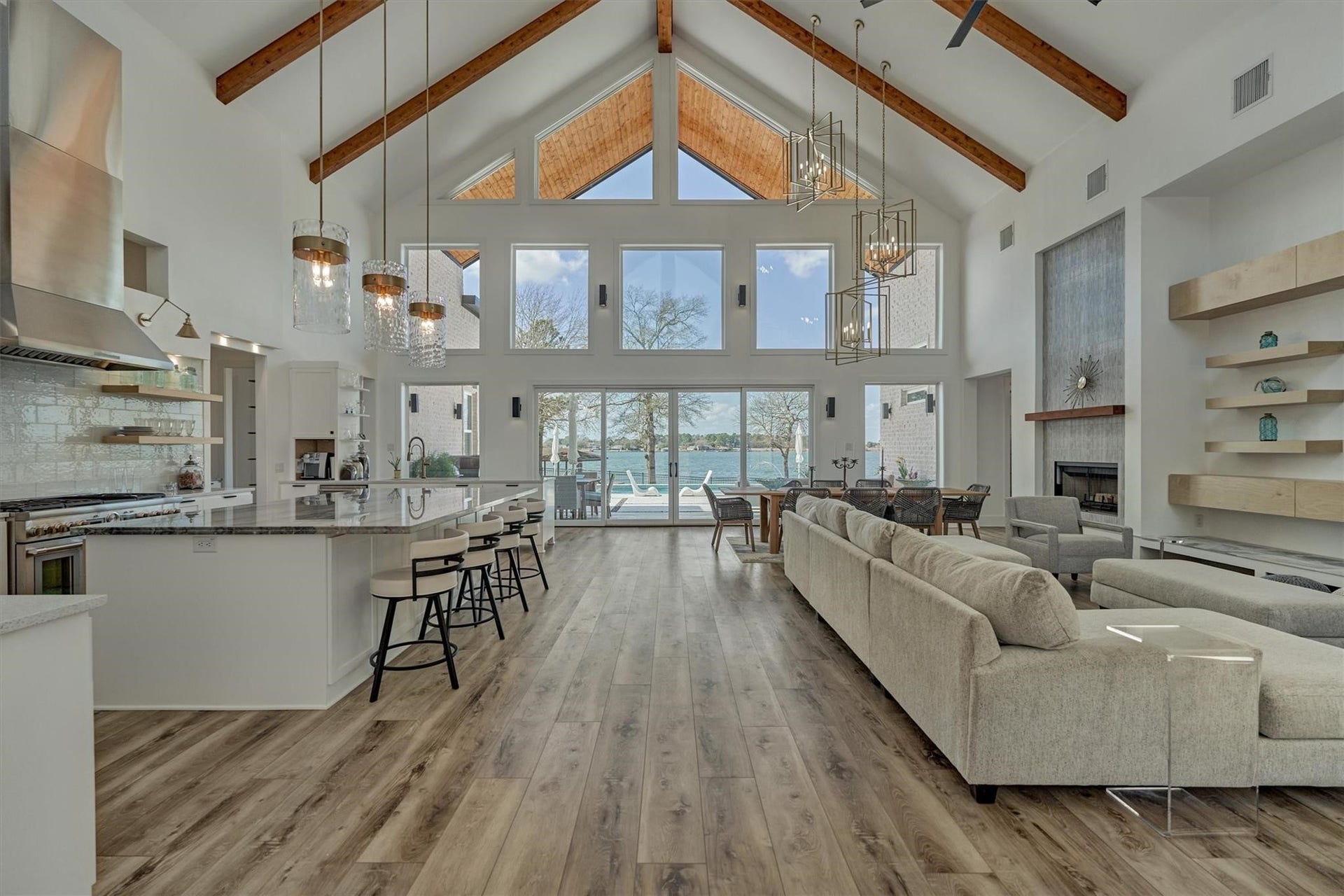 9228 Lake Conroe Drive, Conroe, TX 77304 Enter into this home and appreciate the coastal modern design elements, setting a serene and sophisticated tone throughout. The open floor plan flows seamlessly with luxury plank flooring that enhances the space making it ideal for both entertaining and taking in the stunning views this home as to offer.