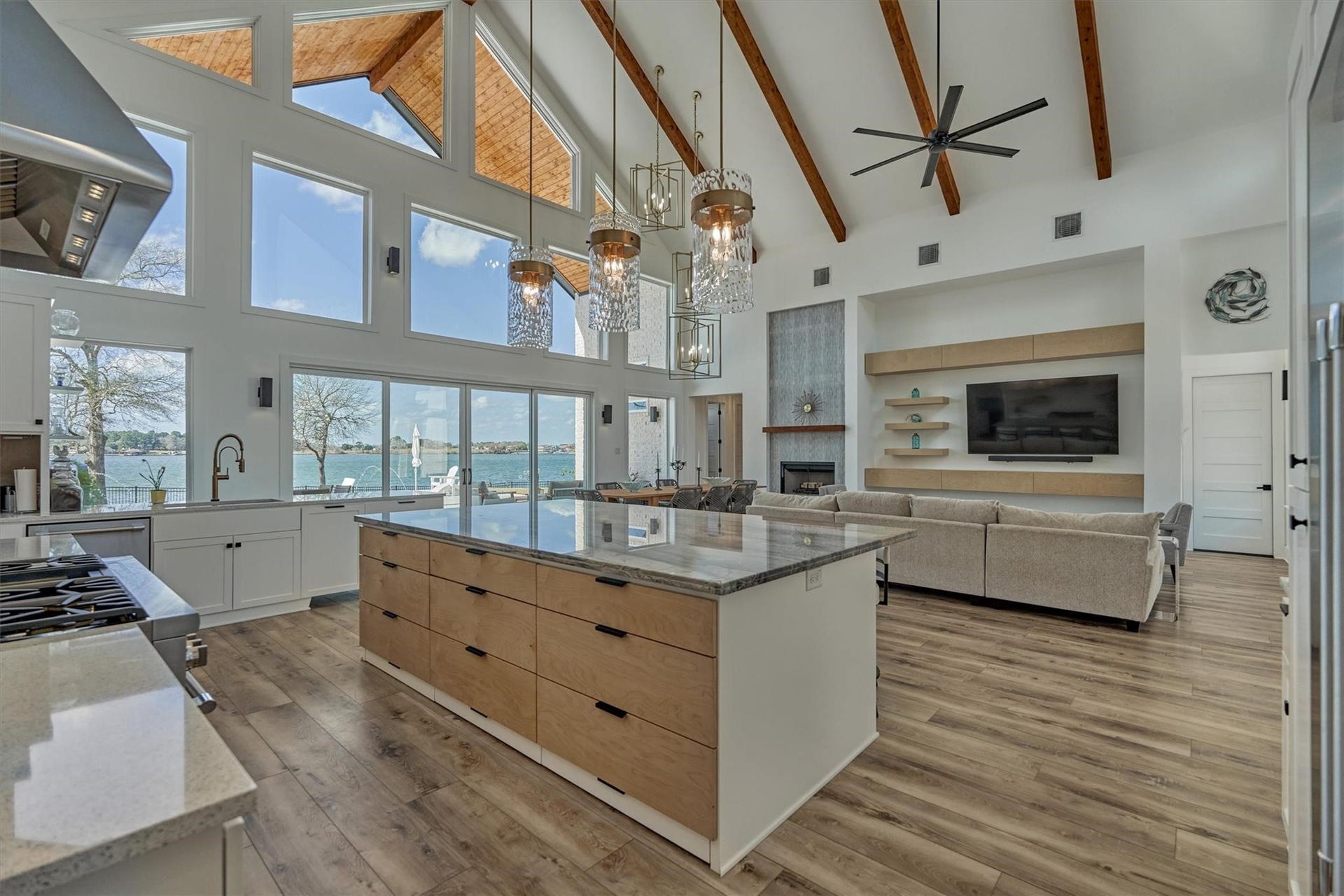 9228 Lake Conroe Drive, Conroe, TX 77304 Wood drawers in the island beautifully coordinate with other wood finishes in the home, enhanced by modern hardware and a soft-close feature. Thoughtfully added drawers at the floor level hold slender utensils and sheet pans.
