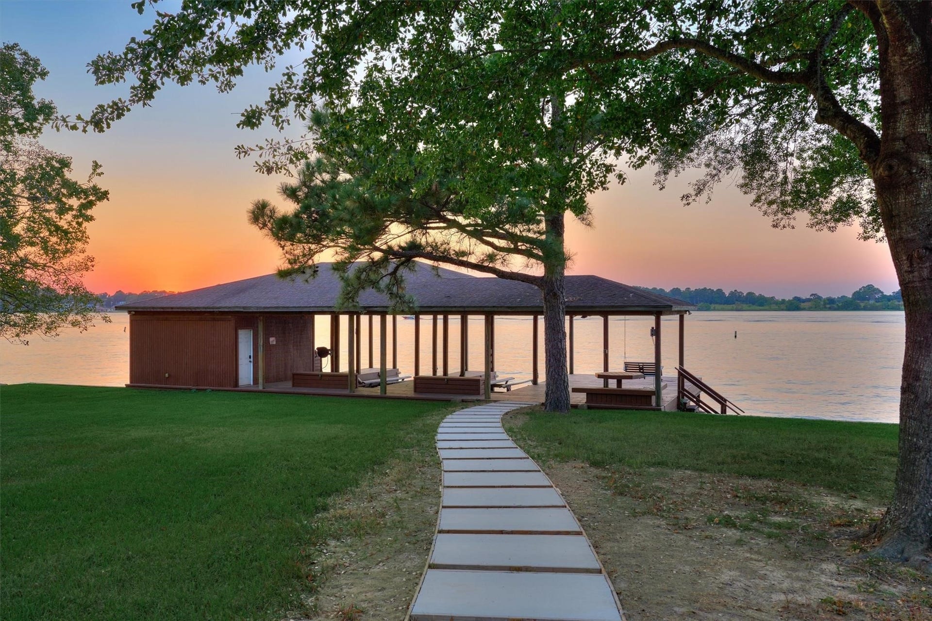 9228 Lake Conroe Drive, Conroe, TX 77304 8. A boat house provides slips and lifts for two boats and two jet skis. Steps leading down to the water offer easy access to the lake for water recreation.