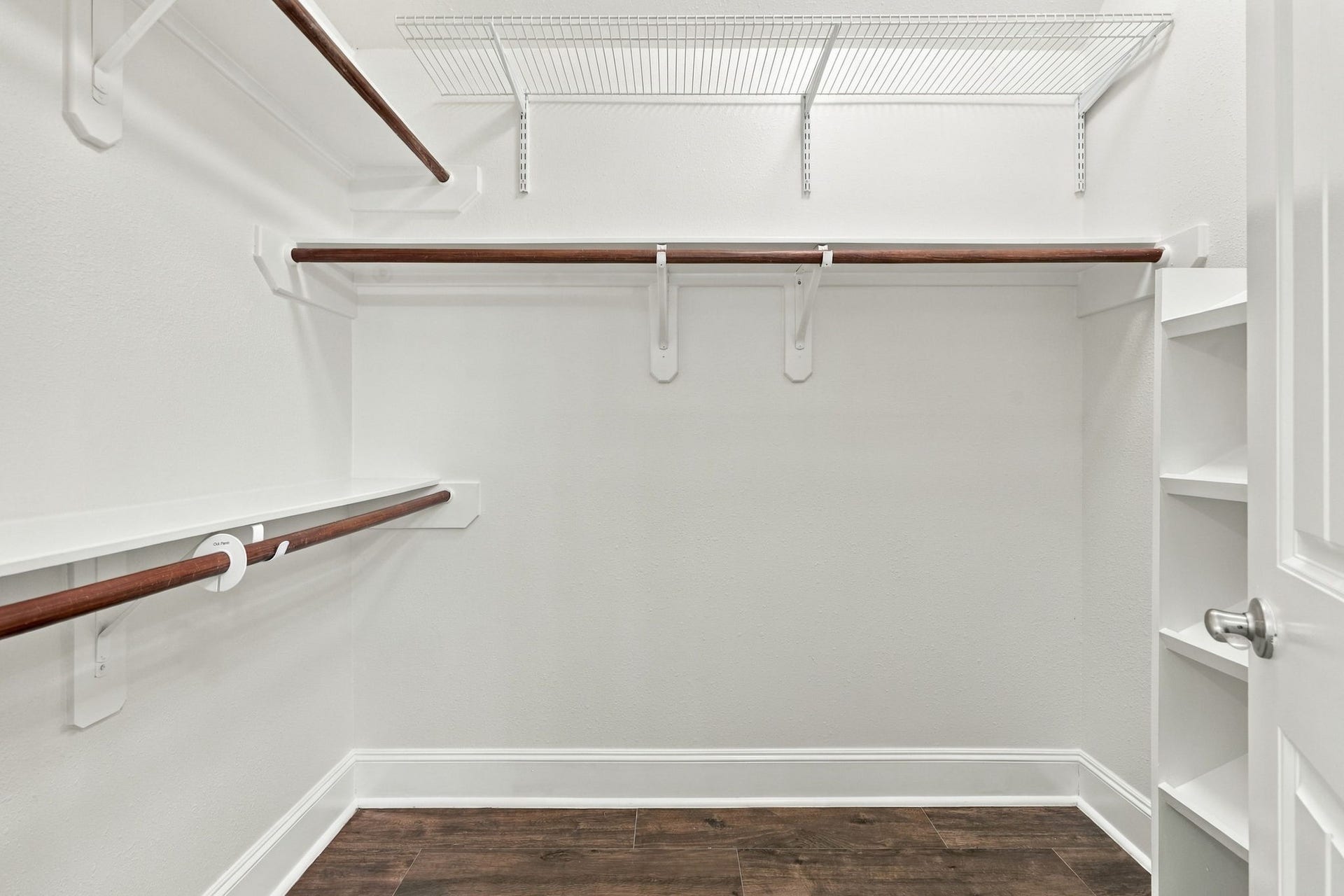 33211 Woodton Court, Fulshear, TX 77441 Here is the second walk-in closet in the Primary Suite, featuring custom built-ins and an abundance of hanging bars, providing plenty of organized storage for clothing, shoes, and accessories.
