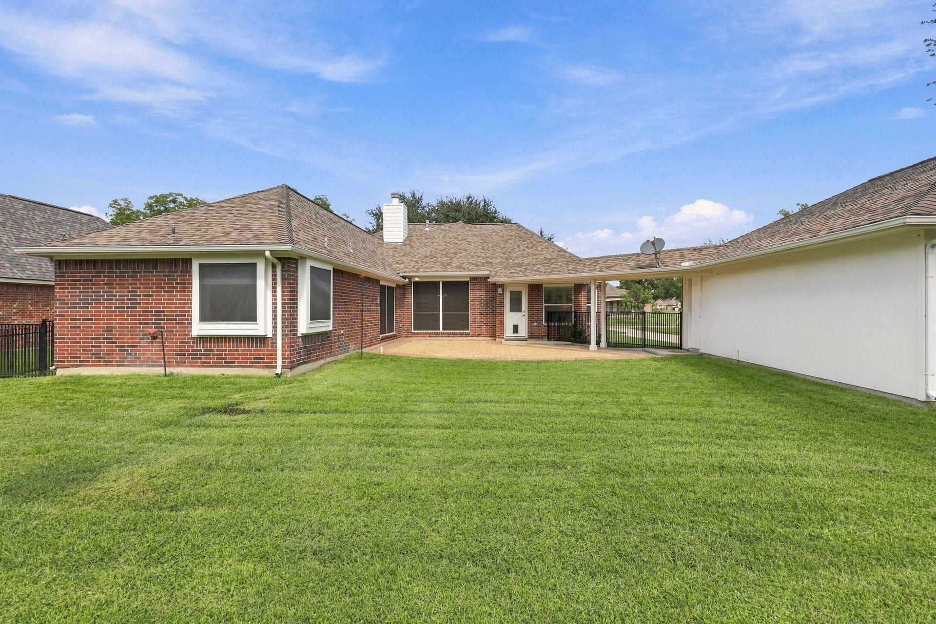 33211 Woodton Court, Fulshear, TX 77441 This view looks from the rear of the property toward the back of the house and showcases the impressive length of the oversized detached Garage, offering abundant space for vehicles, storage, hobbies, or a workshop.