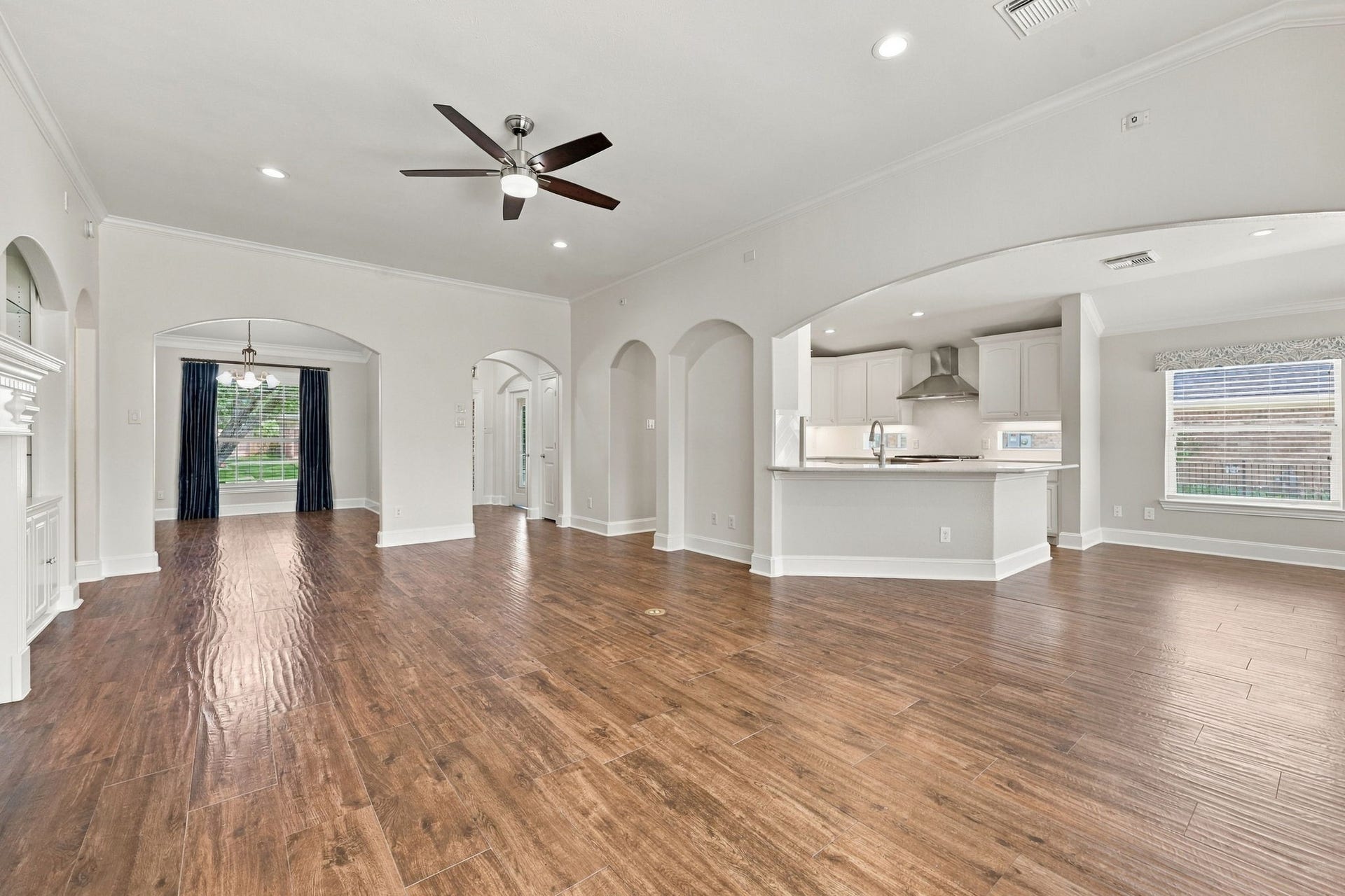 33211 Woodton Court, Fulshear, TX 77441 This view from the Family Room looks toward the Kitchen and Breakfast area and showcases the impressive size and scale of the room. No detail has been overlooked, including the convenient floor outlet, perfect for lamps and other electronics without the need for visible cords.