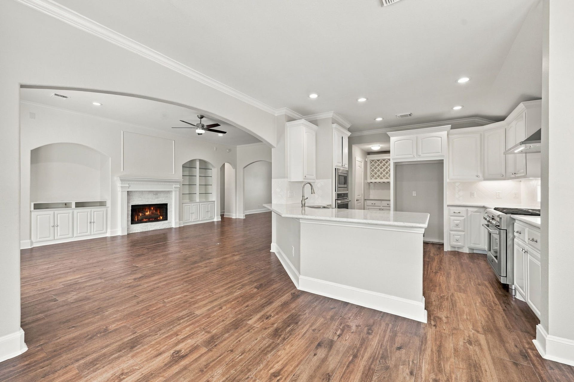33211 Woodton Court, Fulshear, TX 77441 Looking from the Breakfast Area toward the Kitchen and Family Room, this view highlights the seamless flow between the spaces and the open-concept design, making it easy to enjoy everyday living and entertaining.