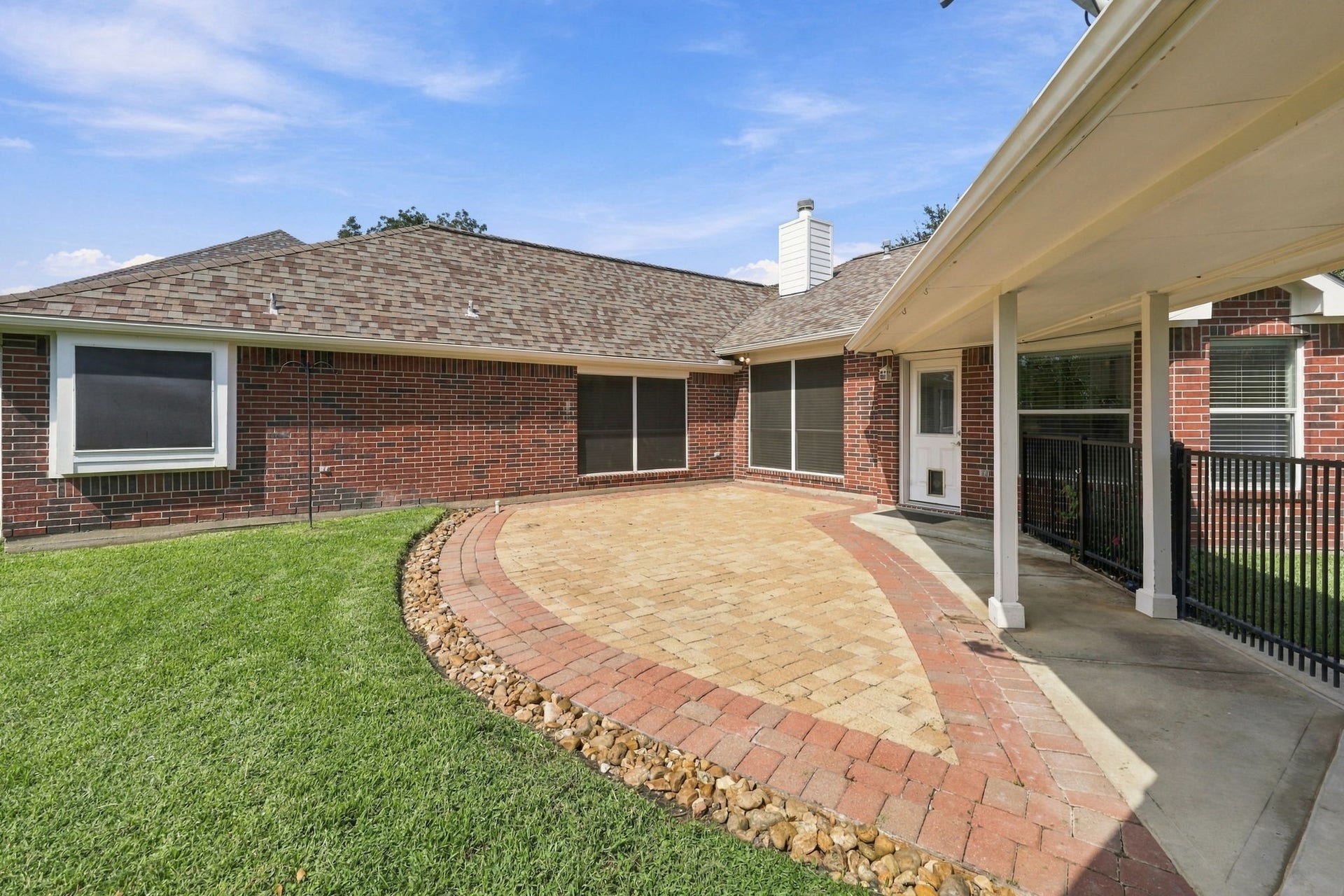 33211 Woodton Court, Fulshear, TX 77441 The extended patio is beautifully finished with a decorative rock border, while the wrought-iron fence and gate along the breezeway help keep children and pets safely in the Backyard. The thoughtfully designed outdoor space offers both beauty and functionality for relaxing and entertaining.