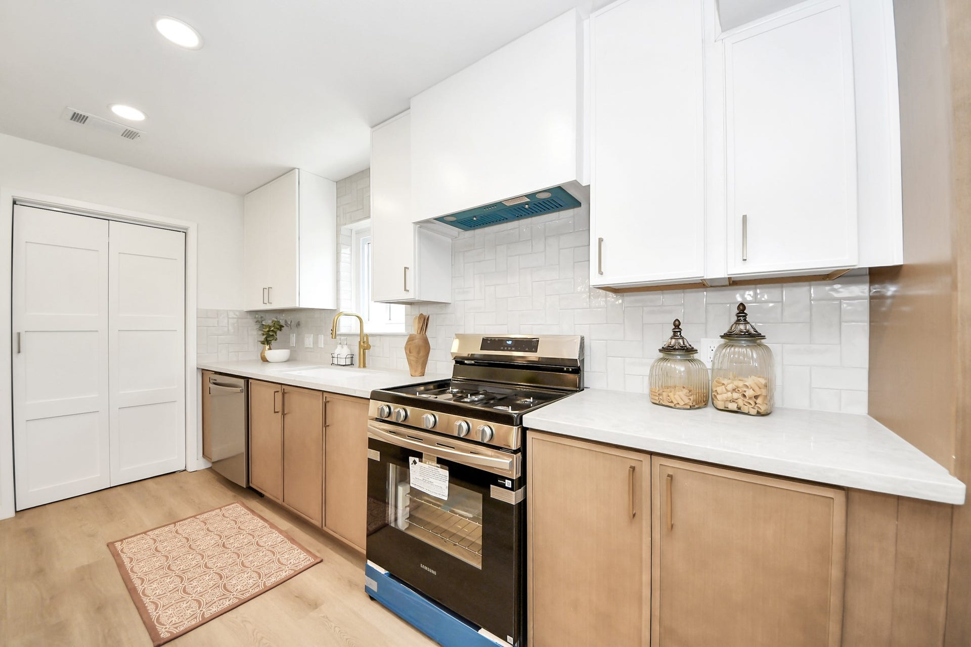 5946 Willowbend Boulevard, Houston, TX 77096 Bright chefs kitchen featuring quartz countertops, sleek vent hood, new cabinetry, and premium finishes throughout.