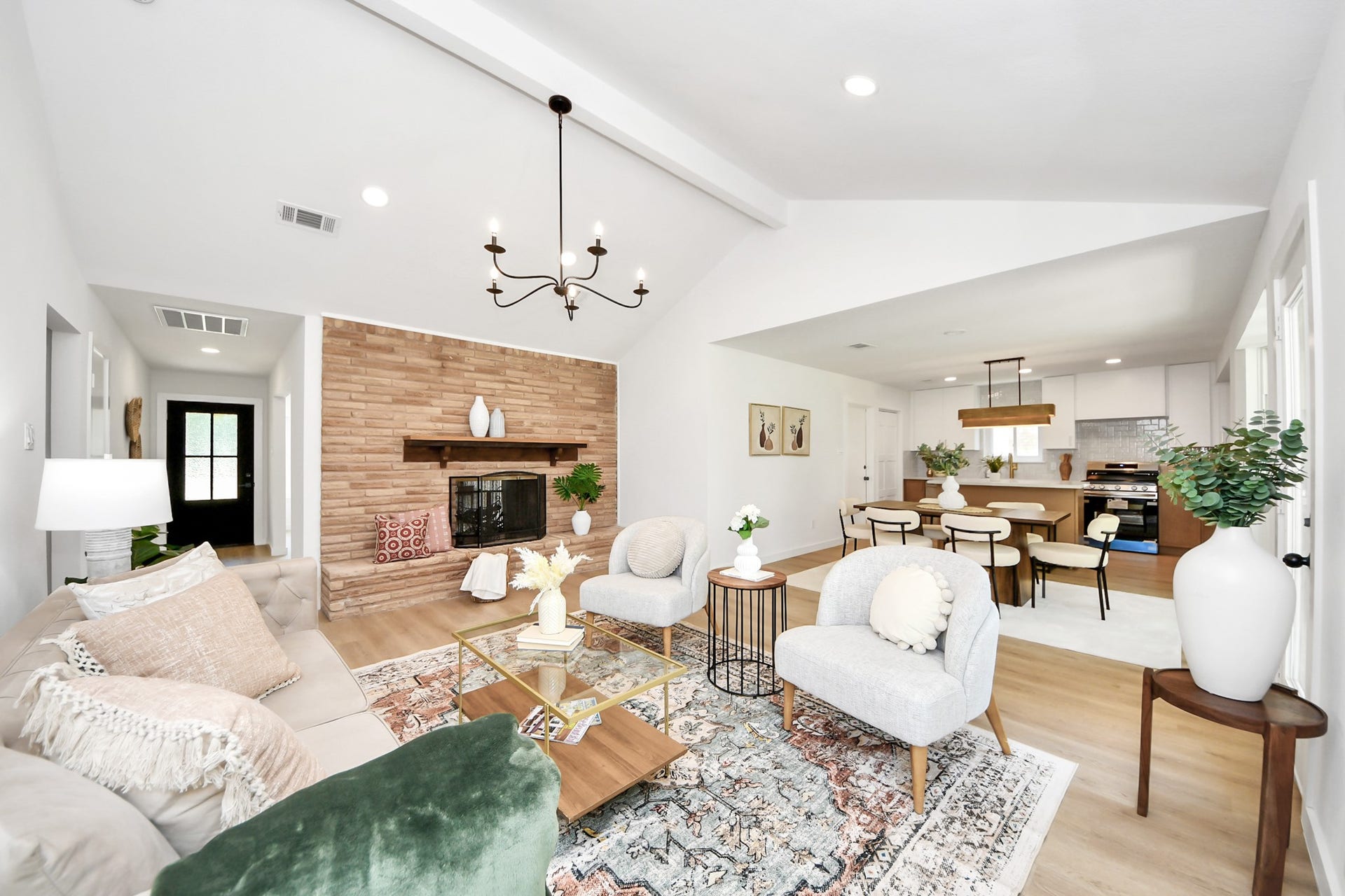 5946 Willowbend Boulevard, Houston, TX 77096 Open-concept living area with soaring ceilings, designer finishes, statement fireplace wall, and seamless flow into the dining and kitchen spaces.