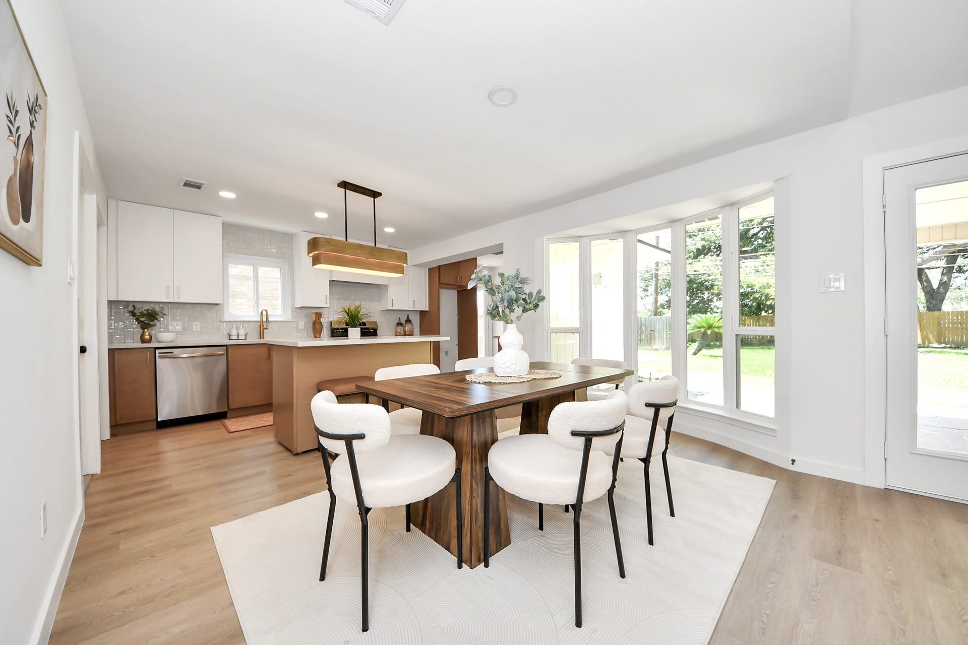 5946 Willowbend Boulevard, Houston, TX 77096 Bright dining and kitchen area with large picture windows, designer lighting, and beautiful indoor-outdoor feel.