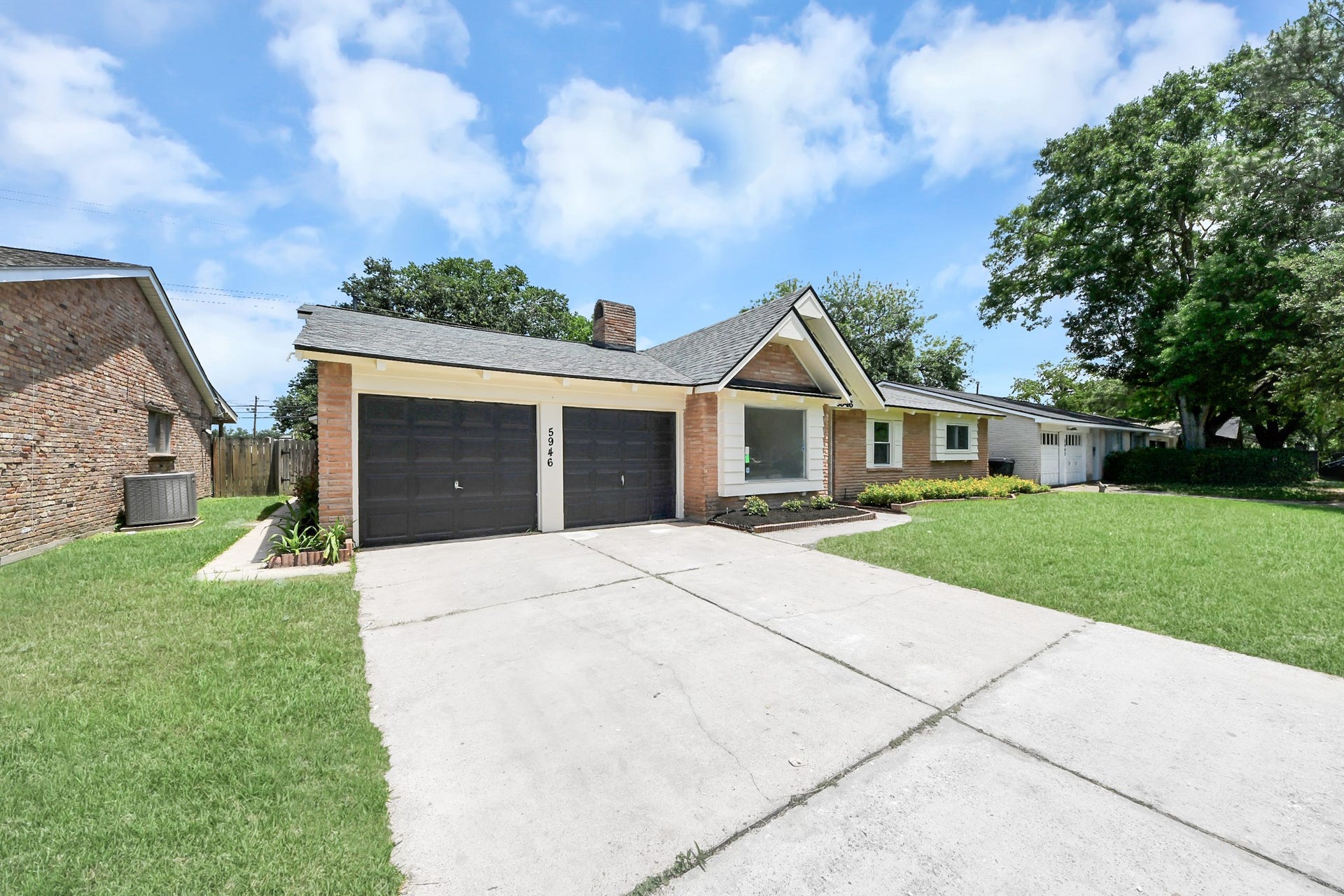 5946 Willowbend Boulevard, Houston, TX 77096 Long private driveway leading to attached garage with charming updated exterior and welcoming front entry.