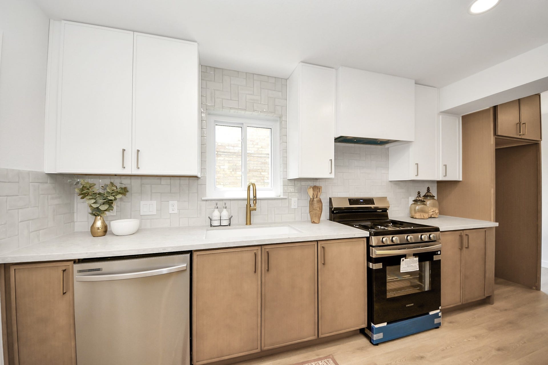 5946 Willowbend Boulevard, Houston, TX 77096 Bright and airy kitchen with quartz countertops, new cabinetry, stainless steel appliances, and oversized island with seating.