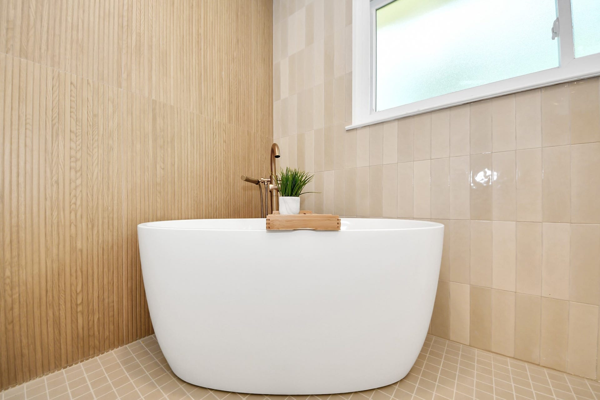5946 Willowbend Boulevard, Houston, TX 77096 Elegant freestanding soaking tub surrounded by warm designer tilework, creating a true spa-like atmosphere.