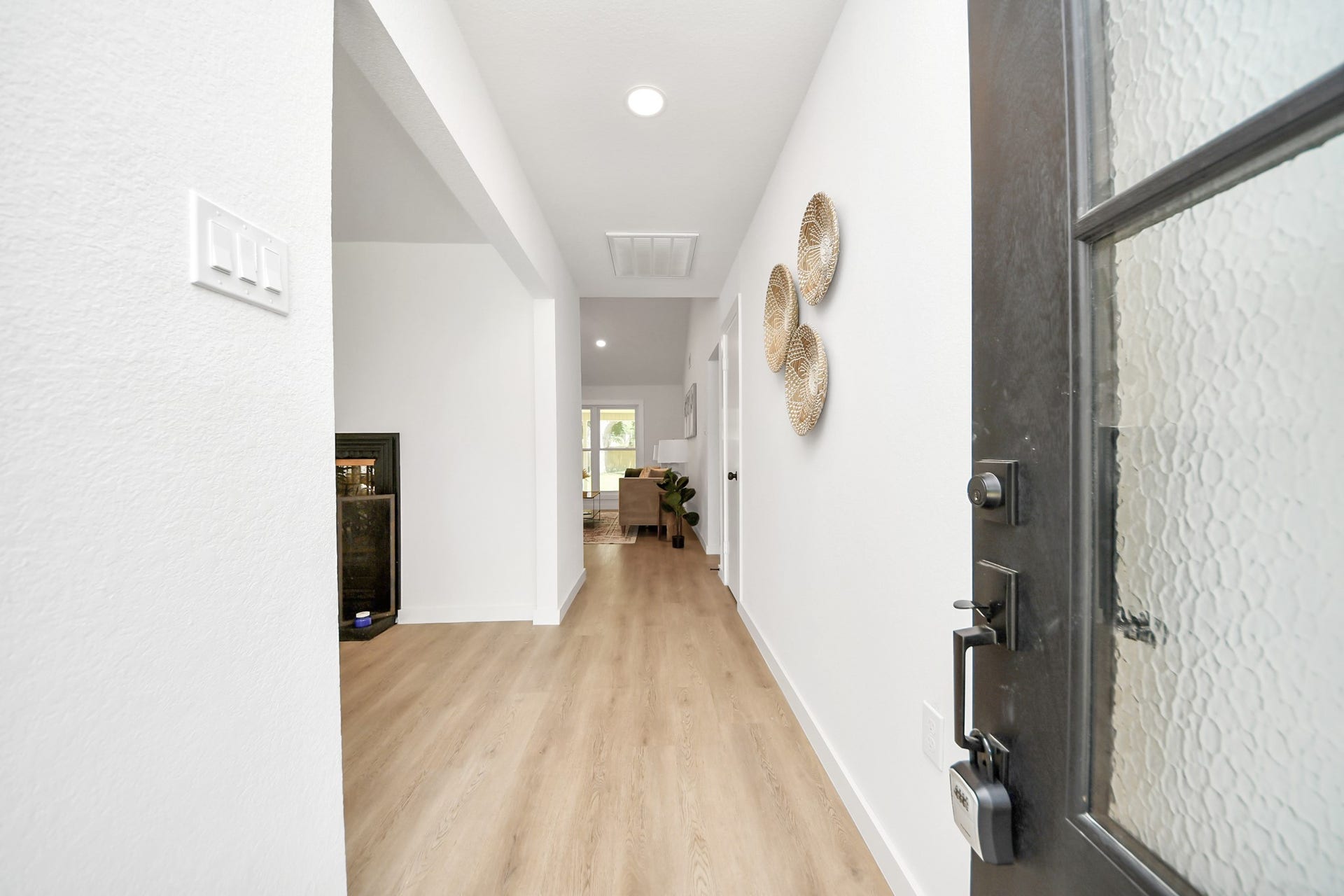 5946 Willowbend Boulevard, Houston, TX 77096 Welcoming entry hallway with modern front door, light wood flooring, and clean contemporary finishes throughout.