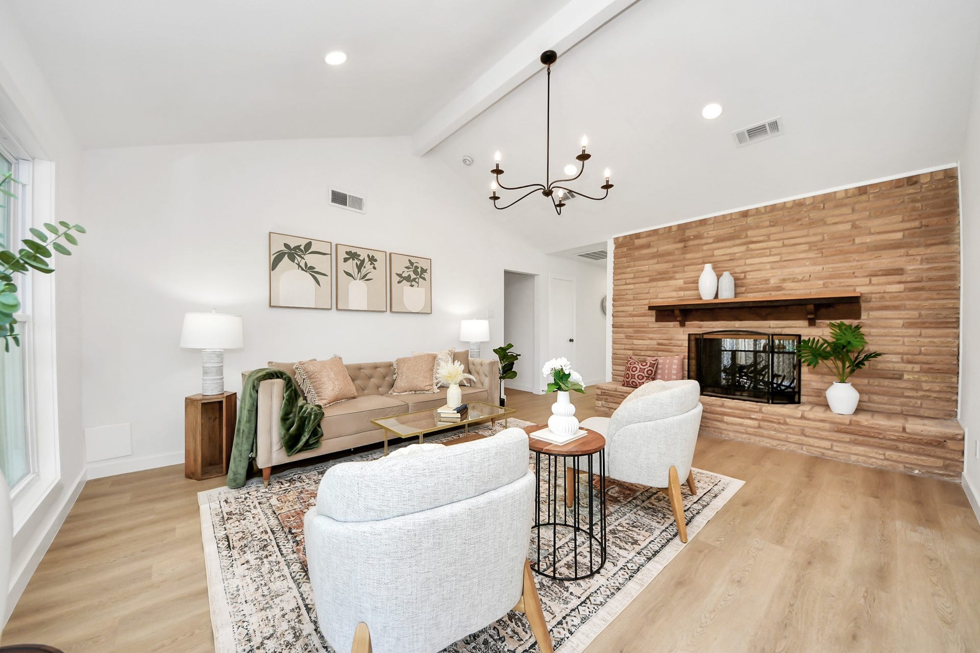 5946 Willowbend Boulevard, Houston, TX 77096 Designer living area showcasing custom wood accent fireplace wall, modern lighting, and open sightlines throughout the home.