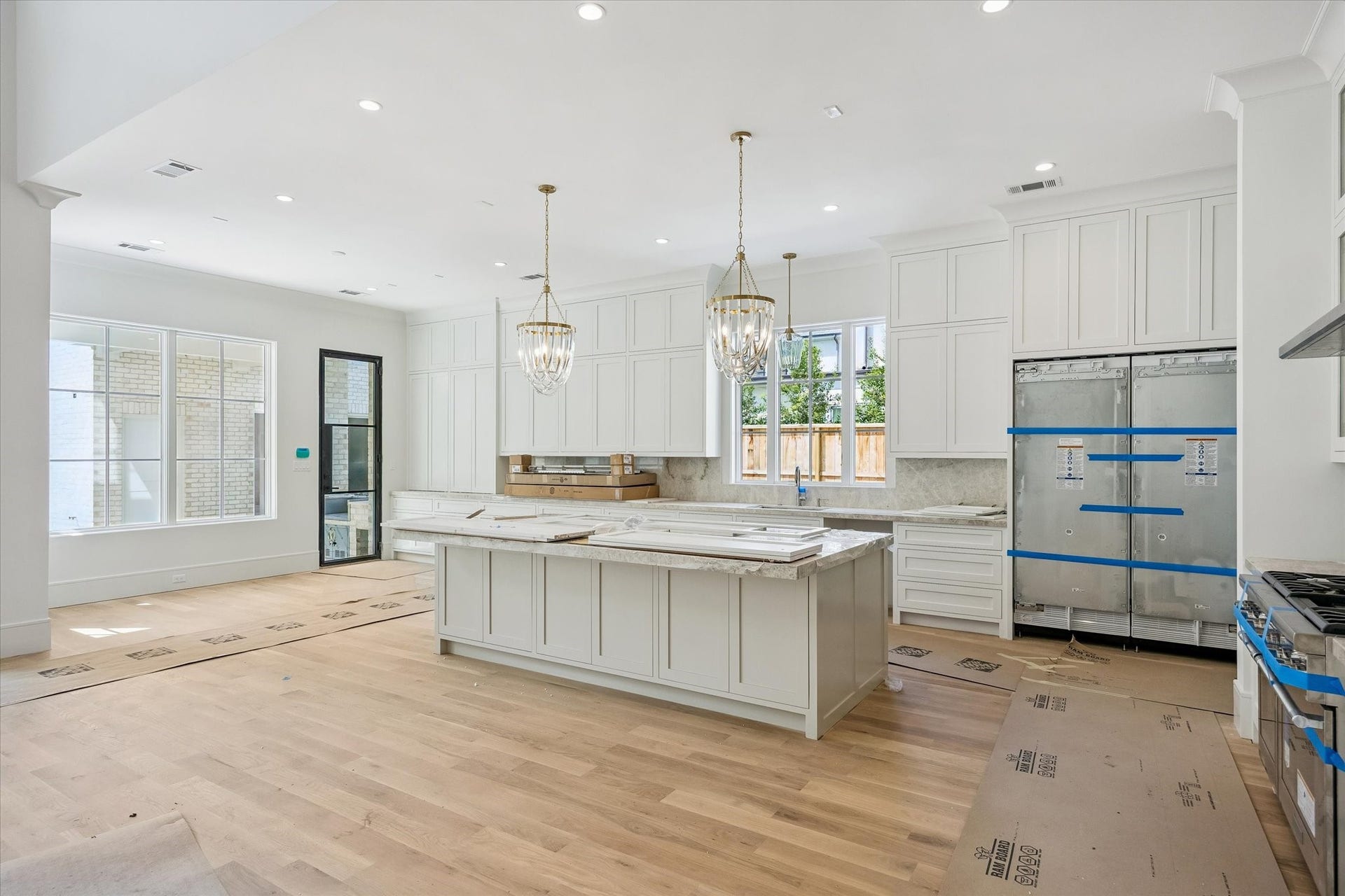 6011 Stones Throw Road, Houston, TX 77057 Kitchen features designer pendant lighting, quartzite countertops, a spacious island, floor-to-ceiling cabinetry, and a charming breakfast nook.