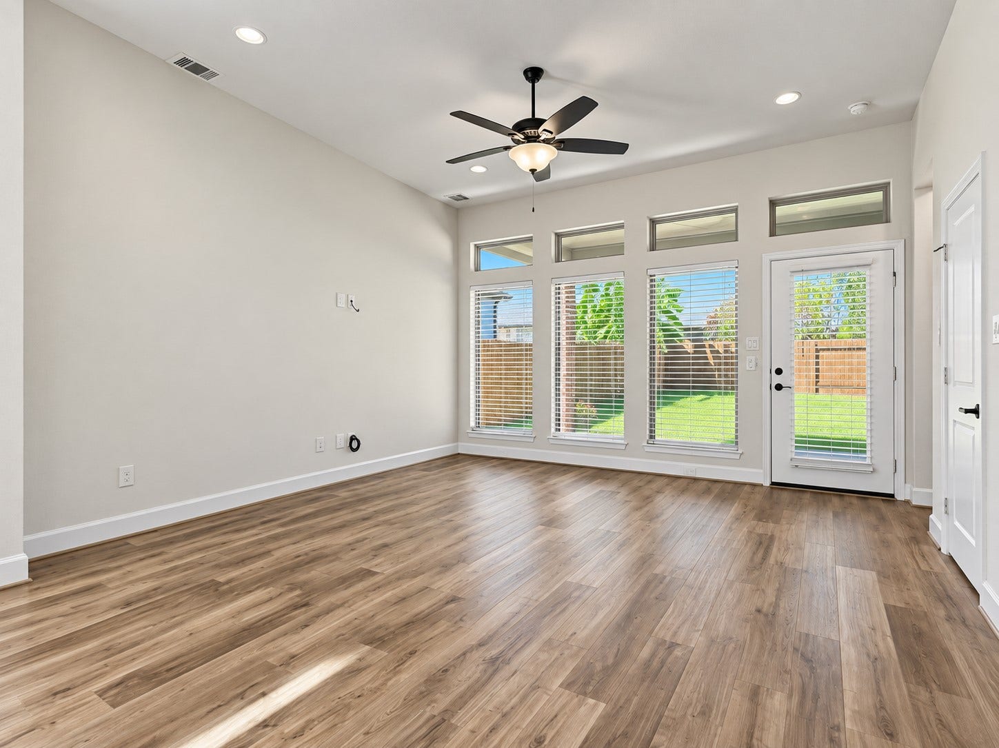 146 Dove Springs Court, Conroe, TX 77304 Natural light fills the living area and creates an easy connection between the kitchen, dining space, and backyard views.