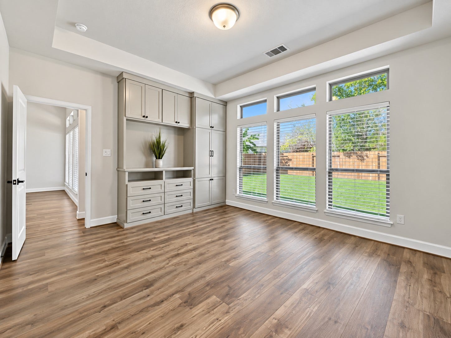 146 Dove Springs Court, Conroe, TX 77304 The spacious primary bedroom gives you room to create a comfortable retreat at the end of the day, with custom built-in cabinetry adding both function and personality.