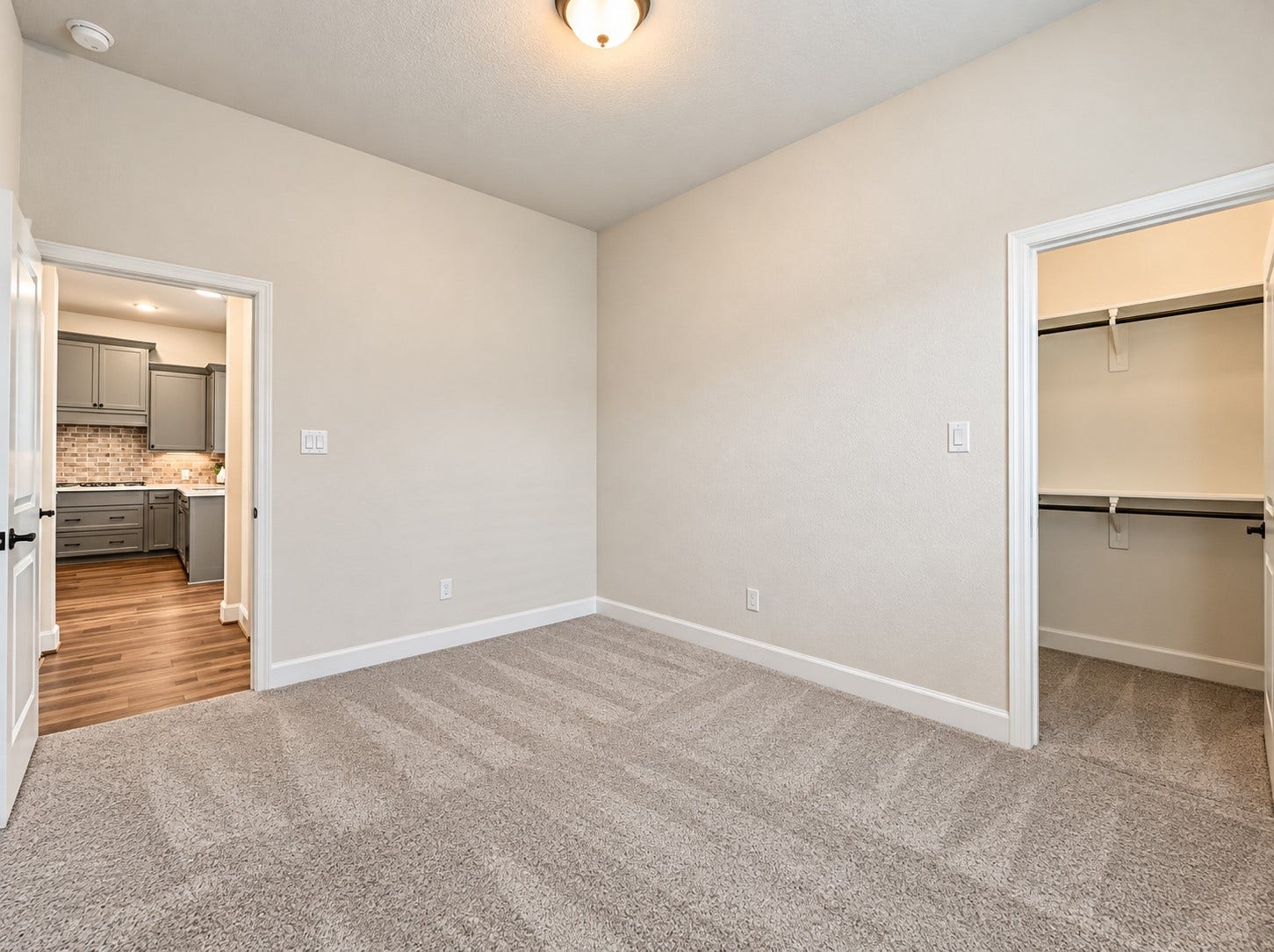 146 Dove Springs Court, Conroe, TX 77304 The downstairs secondary bedroom offers a comfortable retreat for guests or family members, with a full bathroom nearby for added convenience.
