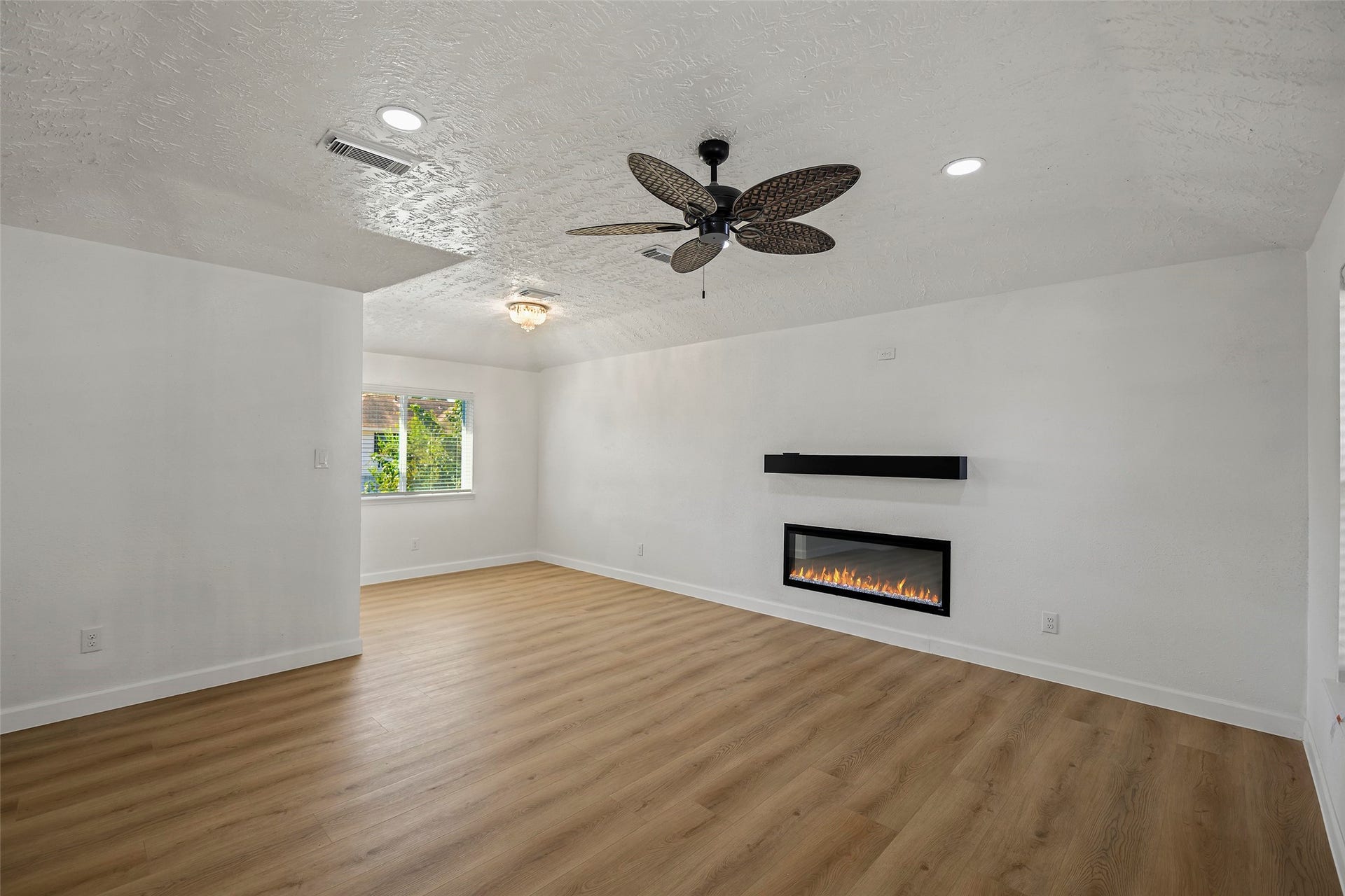 19331 Diversion Drive, Tomball, TX 77375 Spacious living area with vaulted ceilings, abundant natural light, and updated flooring.