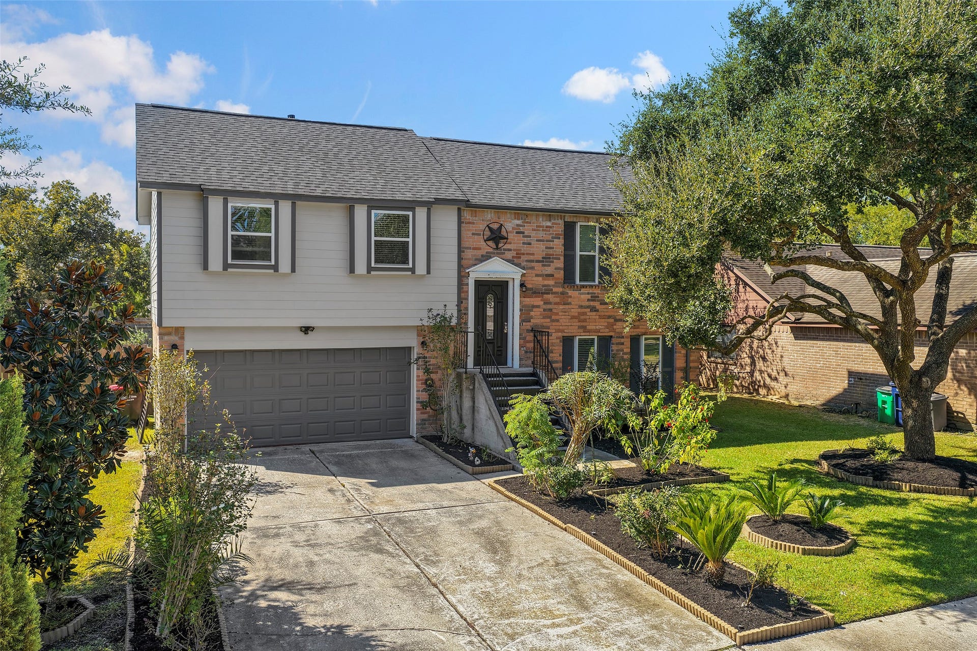19331 Diversion Drive, Tomball, TX 77375 Freshly landscaped front yard with neatly trimmed plants and mature trees