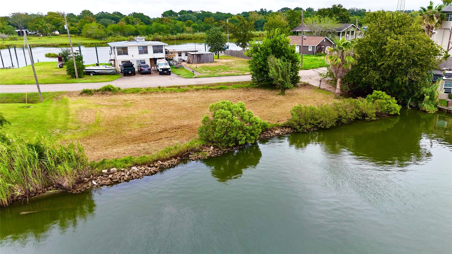 0000 Scenic Drive, Dickinson, TX 77539 Elevated view displaying the property boundaries, natural shoreline, and street access in Tropical Gardens.