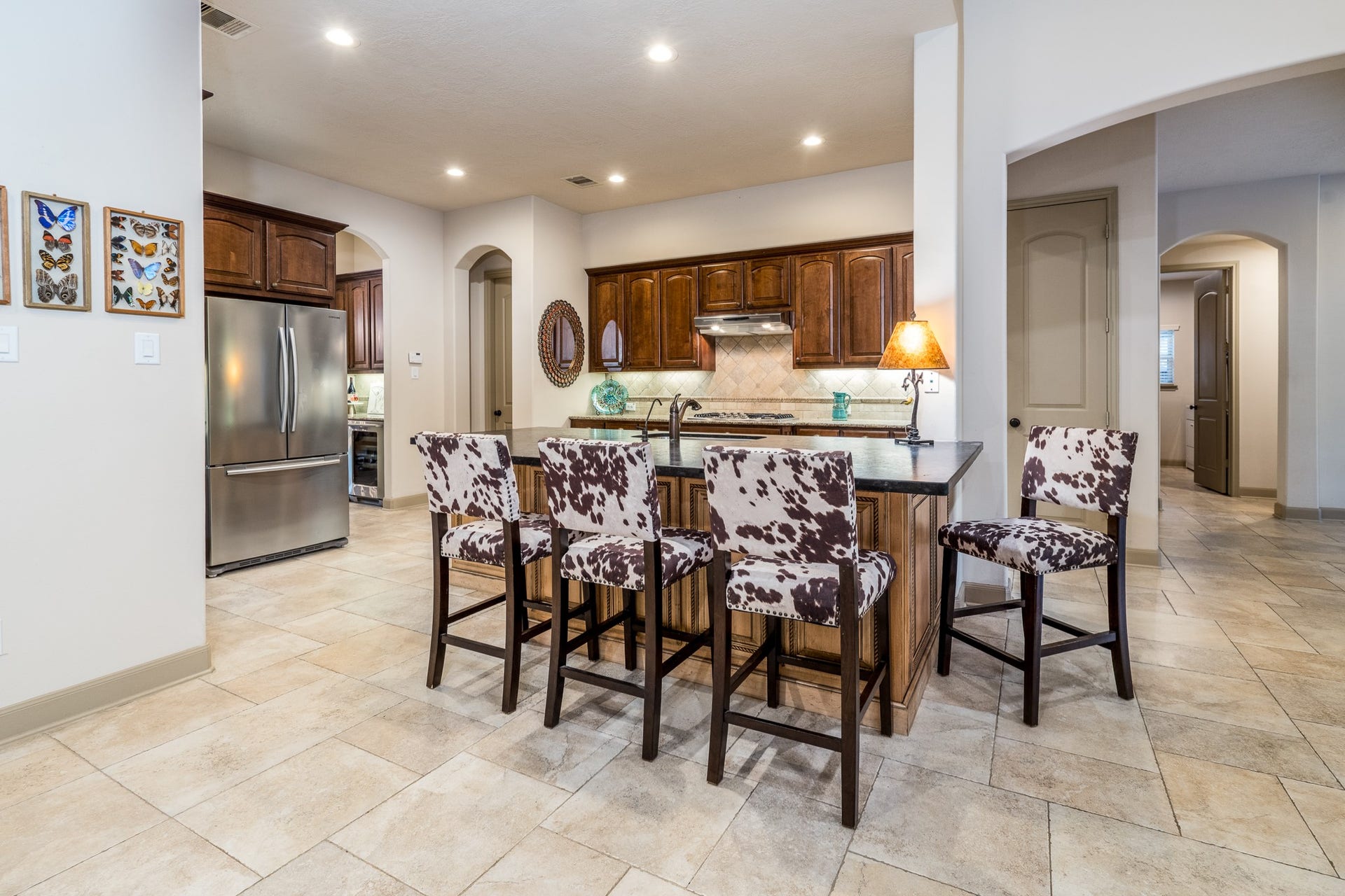 13807 Oak Fair Bend, Cypress, TX 77429 Where culinary inspiration meets timeless elegance! This beautifully remodeled kitchen is a true showpiece, featuring a spectacular statement island crowned with luxurious leather-finished granite that adds rich texture and sophisticated character. Abundant cabinetry, generous prep space, and an inviting breakfast bar create the perfect setting for everything from morning coffee to memorable gatherings. Seamlessly connected to the spacious family room, this exceptional kitchen is designed for those who love