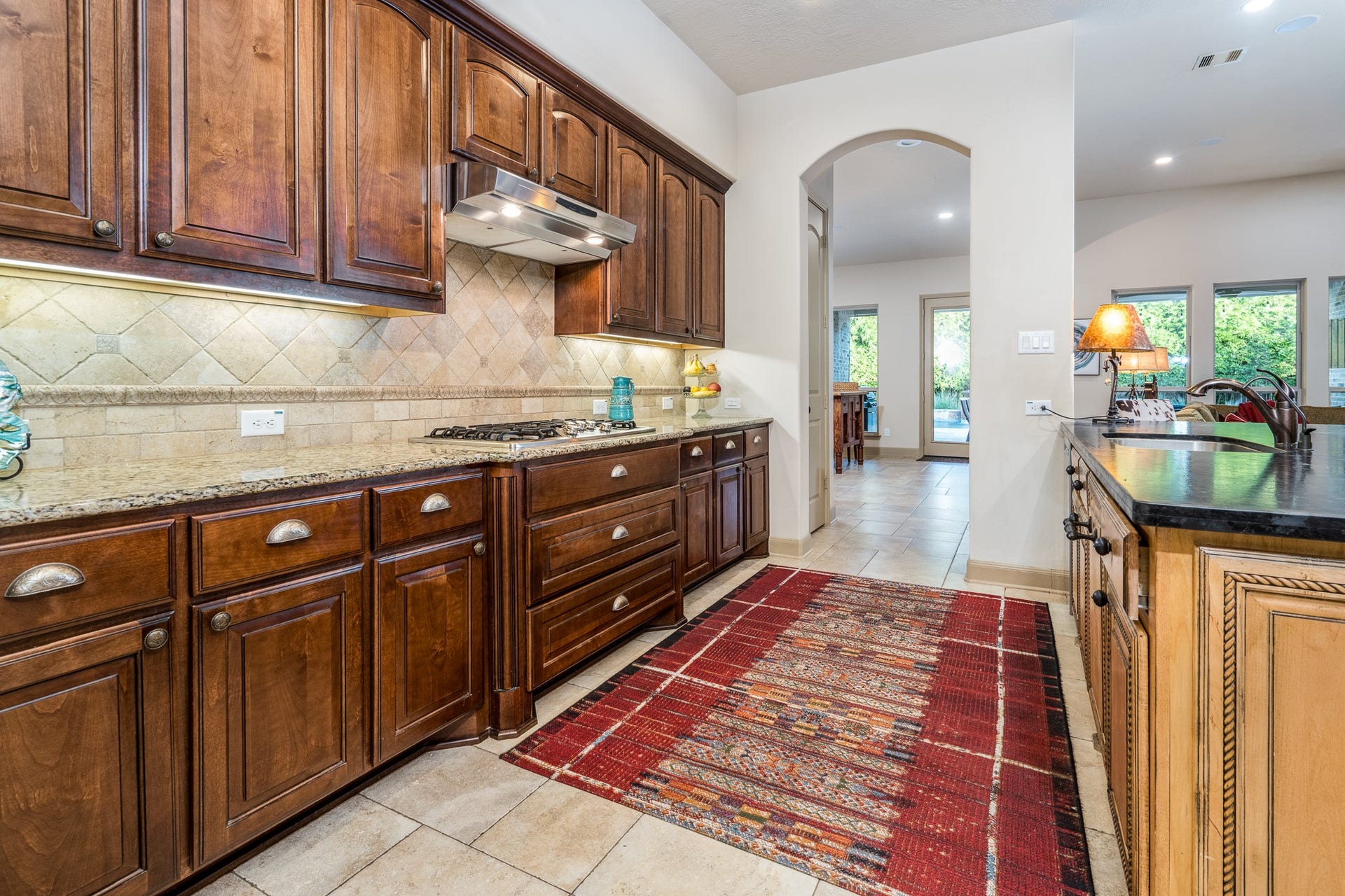 13807 Oak Fair Bend, Cypress, TX 77429 A culinary masterpiece! This beautifully gourmet kitchen showcases a stunning oversized island with luxurious leather-finished granite, gleaming granite countertops, abundant cabinetry, and elegant designer finishes.