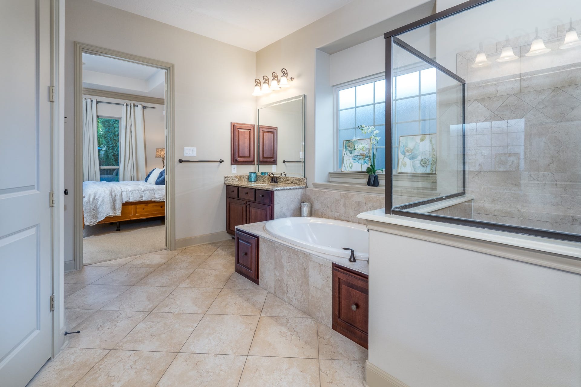 13807 Oak Fair Bend, Cypress, TX 77429 YOUR OWN PRIVATE SPA EXPERIENCE, JUST STEPS FROM YOUR BEDROOM! Imagine beginning each morning surrounded by natural light and ending each evening soaking away the day's stresses in your luxurious jetted tub. This beautifully designed primary ensuite features elegant stone finishes, a spacious glass-enclosed shower, and rich cabinetry with granite countertops. A peaceful sanctuary where everyday moments become little luxuries and relaxation feels effortless!