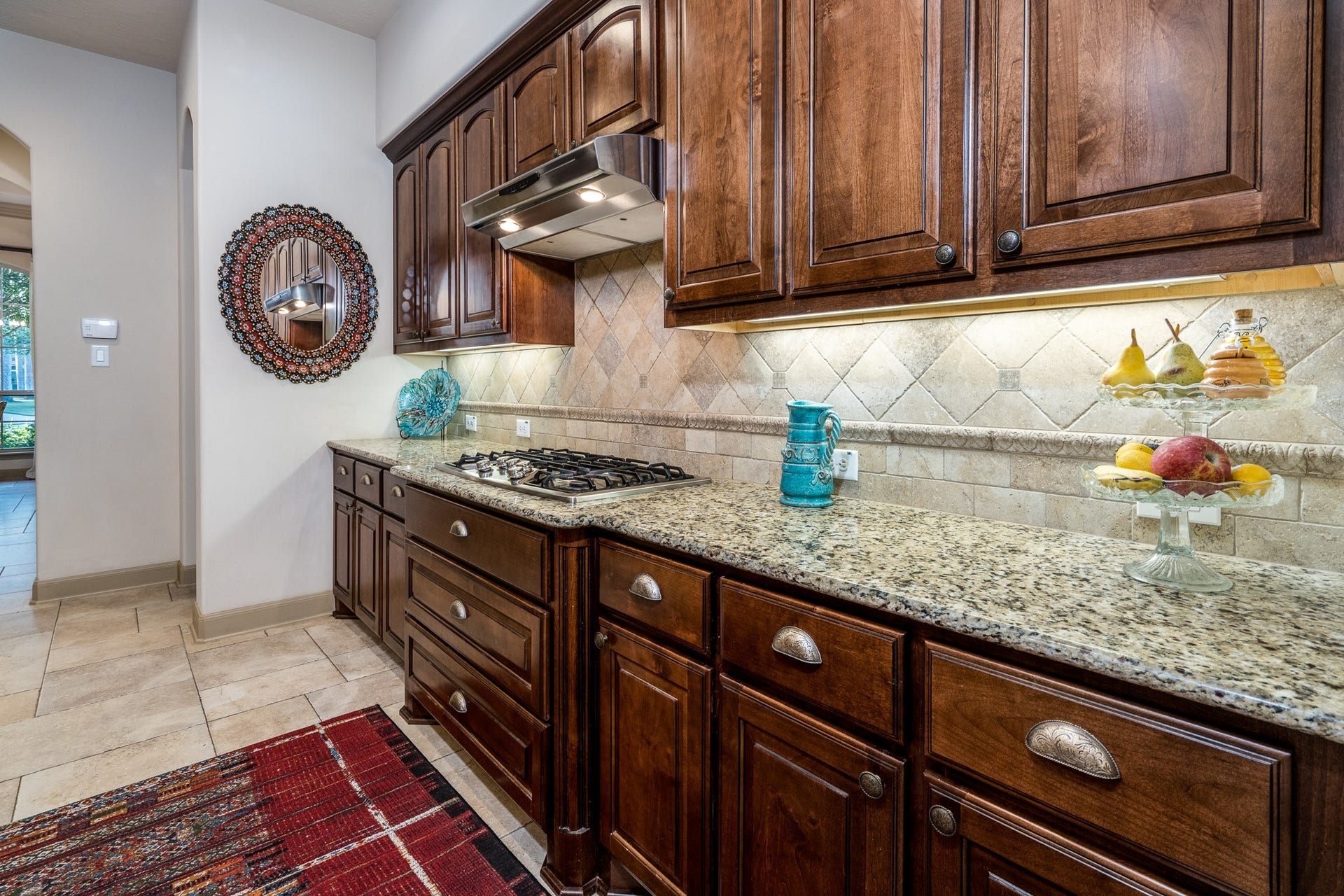 13807 Oak Fair Bend, Cypress, TX 77429 Timeless craftsmanship meets everyday luxury! Beautifully crafted rich wood cabinetry, gleaming granite countertops, and an elegant tile backsplash create a warm, sophisticated atmosphere. Generous counter space and abundant storage offer both beauty and functionality, making this thoughtfully designed kitchen a delightful space for preparing meals, entertaining guests, and enjoying life's everyday moments.