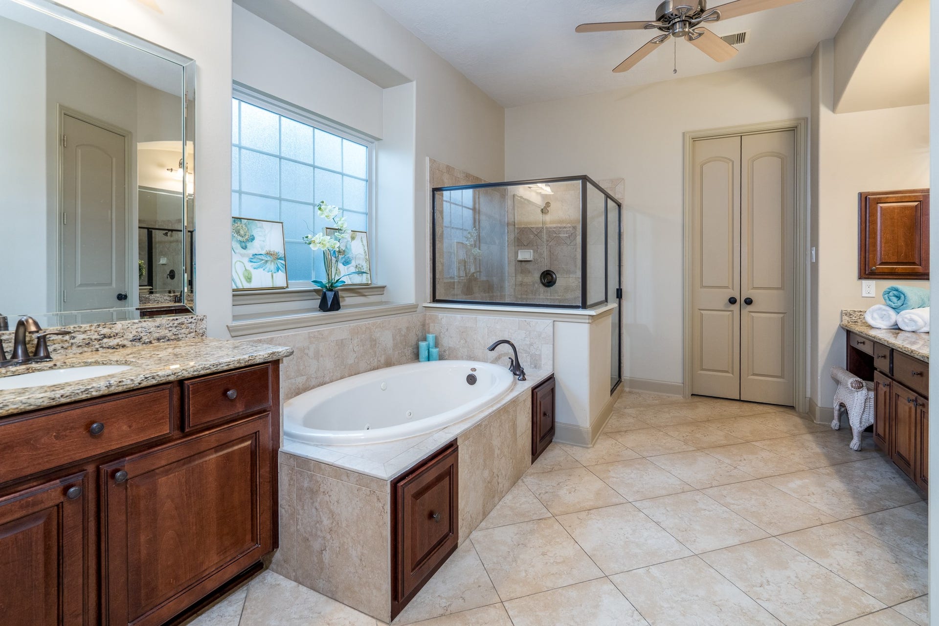 13807 Oak Fair Bend, Cypress, TX 77429 YOUR PERSONAL SANCTUARY OF PEACE AND INDULGENCE! Imagine escaping the demands of the day and slipping into a luxurious soaking tub, surrounded by beautiful natural stone finishes and soft, natural light. This spacious, spa-inspired primary ensuite features a stunning walk-in shower, elegant granite vanities, and an atmosphere designed for complete relaxation. Because true luxury is having a beautiful place to unwind, recharge, and feel completely at home!