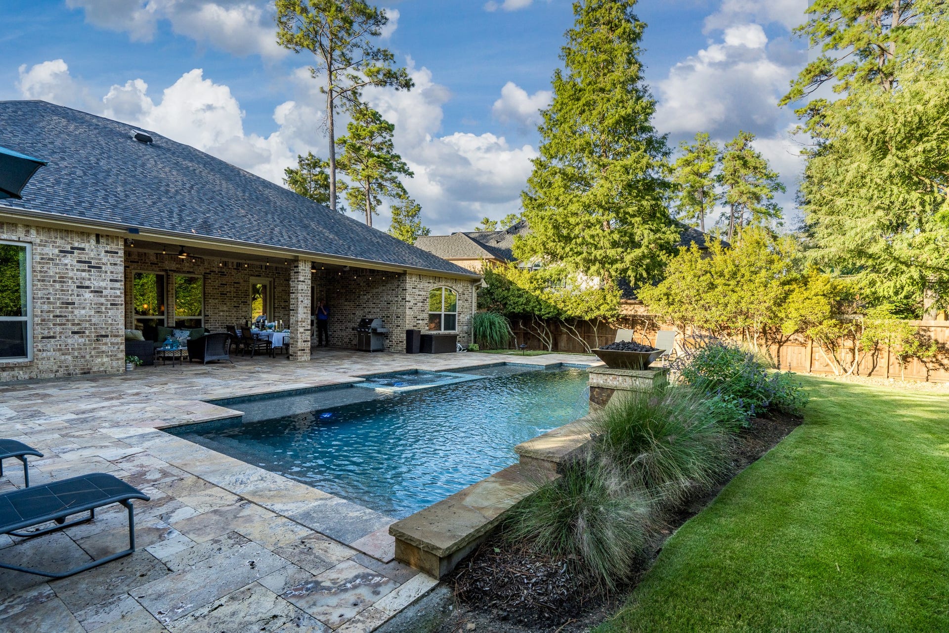 13807 Oak Fair Bend, Cypress, TX 77429 Where Everyday Living Feels Like a Luxury Vacation! This spectacular backyard oasis offers the perfect blend of relaxation, privacy, and outdoor entertaining. A sparkling resort-style pool, expansive natural stone decking, and a spacious covered patio create an inviting setting for gatherings or peaceful afternoons. Surrounded by lush landscaping and a beautifully manicured lawn, this exceptional outdoor retreat is designed for making memories that last a lifetime!