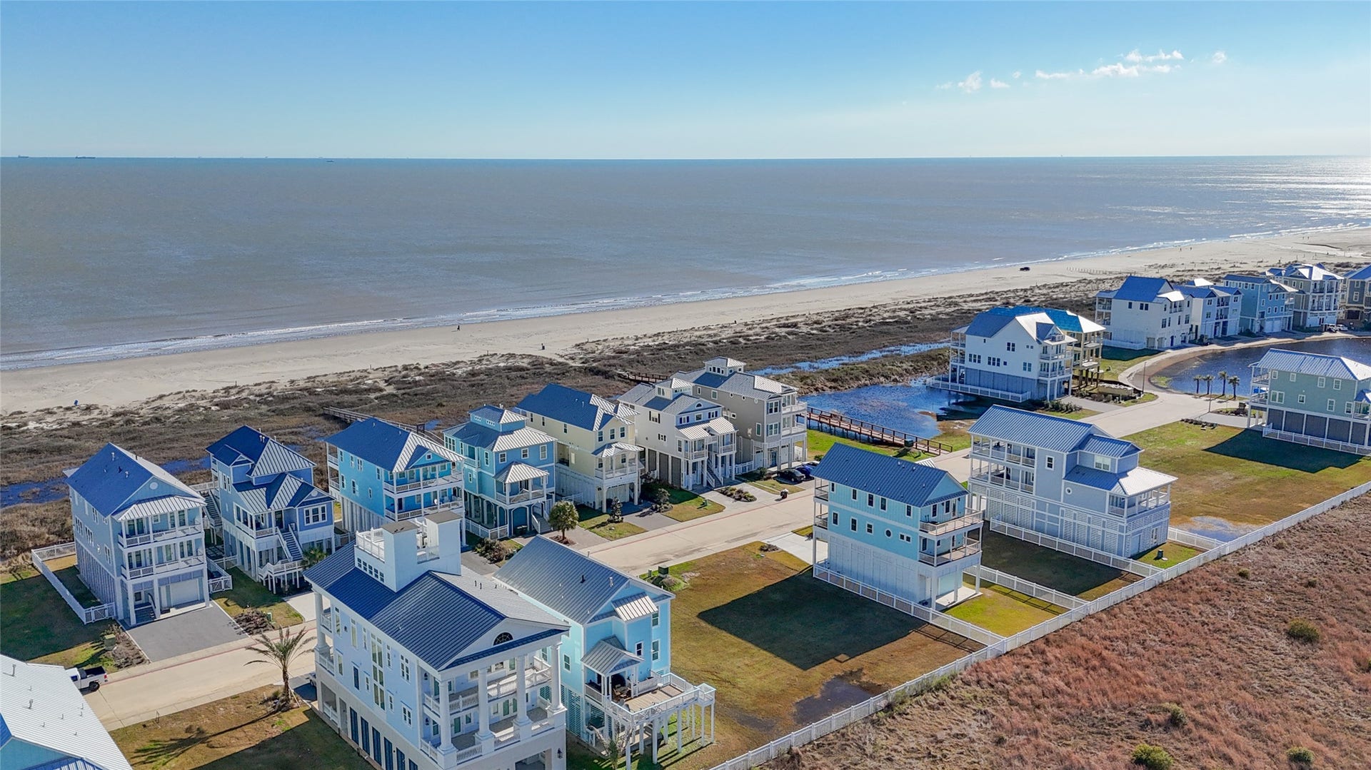 This elevated coastal view emphasizes the neighborhoods remarkable proximity to the Gulf of Mexico and the quiet stretch of beach serving The Preserve at Grand Beach. The homesite sits in the second row behind established coastal residences, allowing a future elevated home to take advantage of its seaside setting without occupying a direct beachfront parcel. Dedicated community walkover access makes reaching the sand and surf especially convenient.