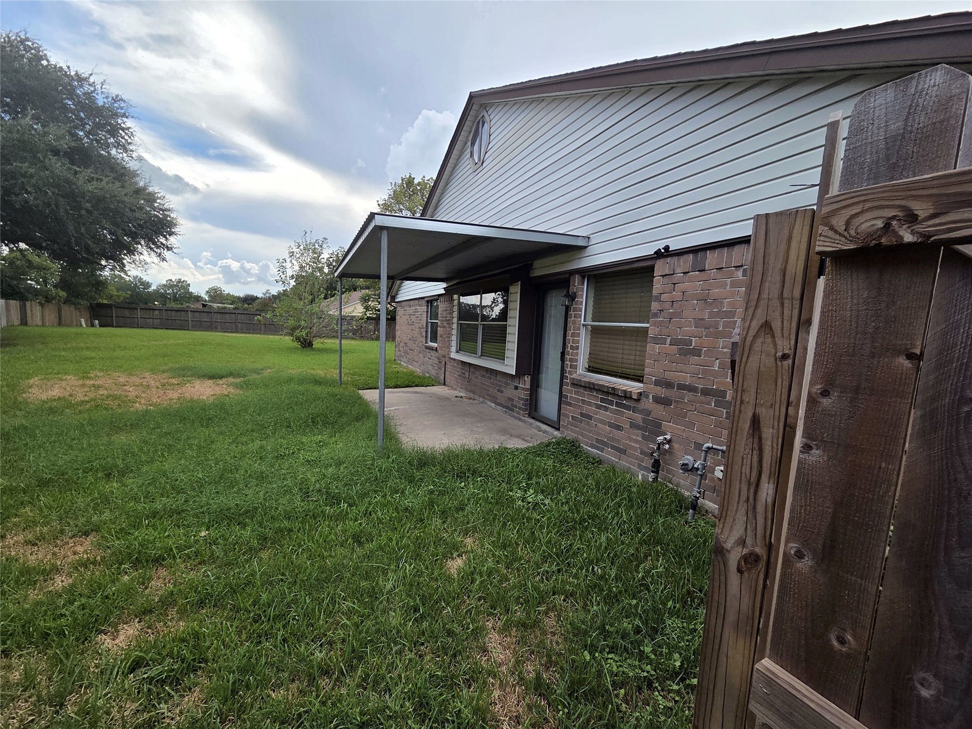 The covered patio opens to the fenced backyard for relaxed outdoor living.