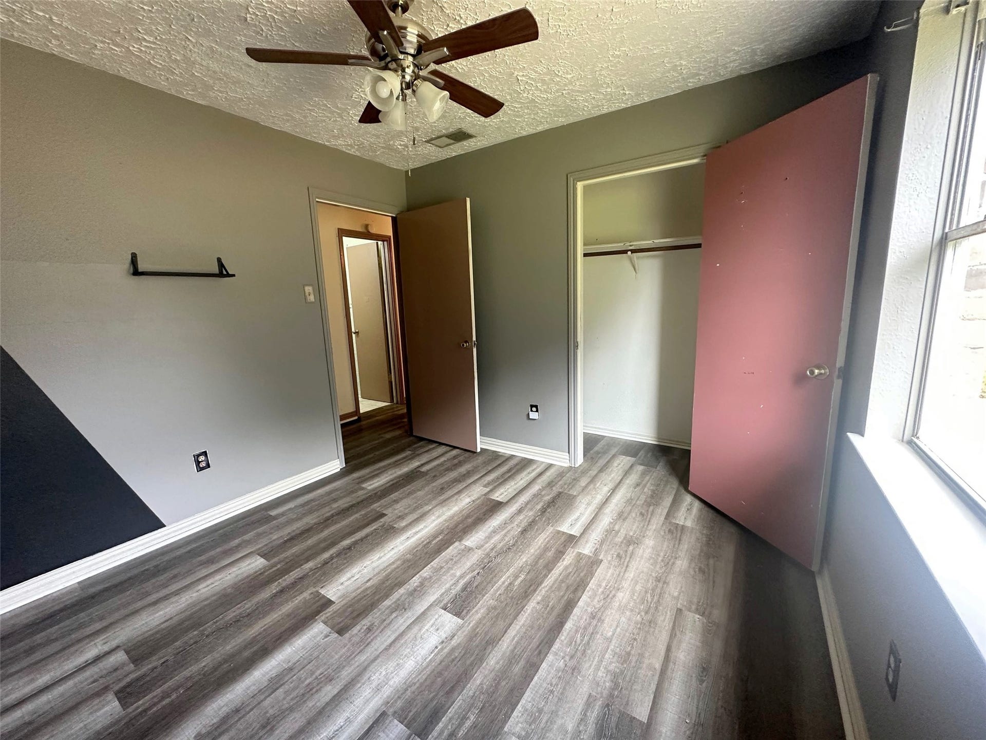 Virtually staged. Light neutral furnishings show the bedroom's scale while keeping closet and hallway access clear.