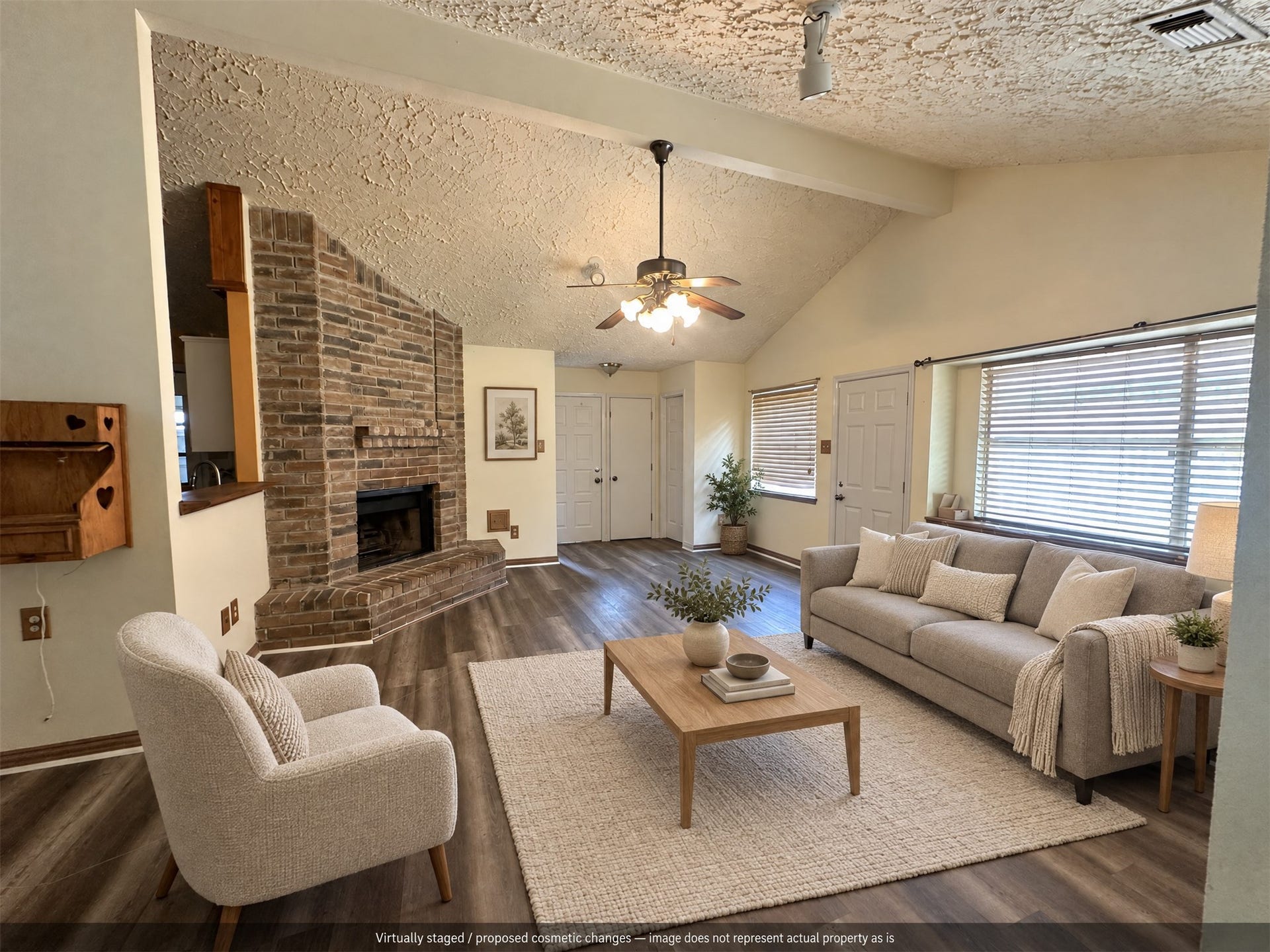 Virtually staged. A cozy seating arrangement highlights the brick fireplace and open living space.