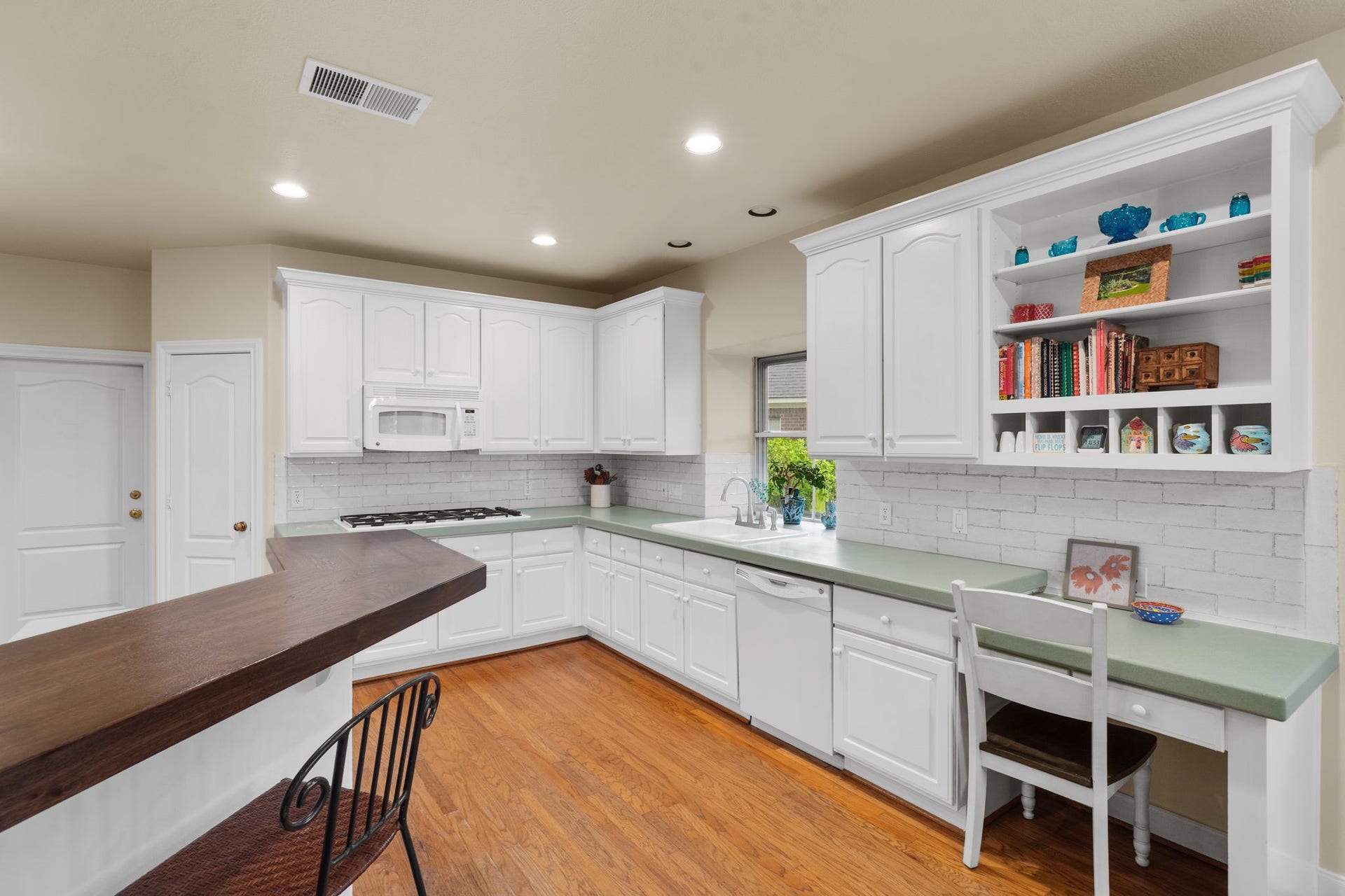 39 Rippling Creek Drive, Sugar Land, TX 77479 An updated subway tile backsplash complements the durable, well-maintained Corian countertops, giving the space a fresh look.