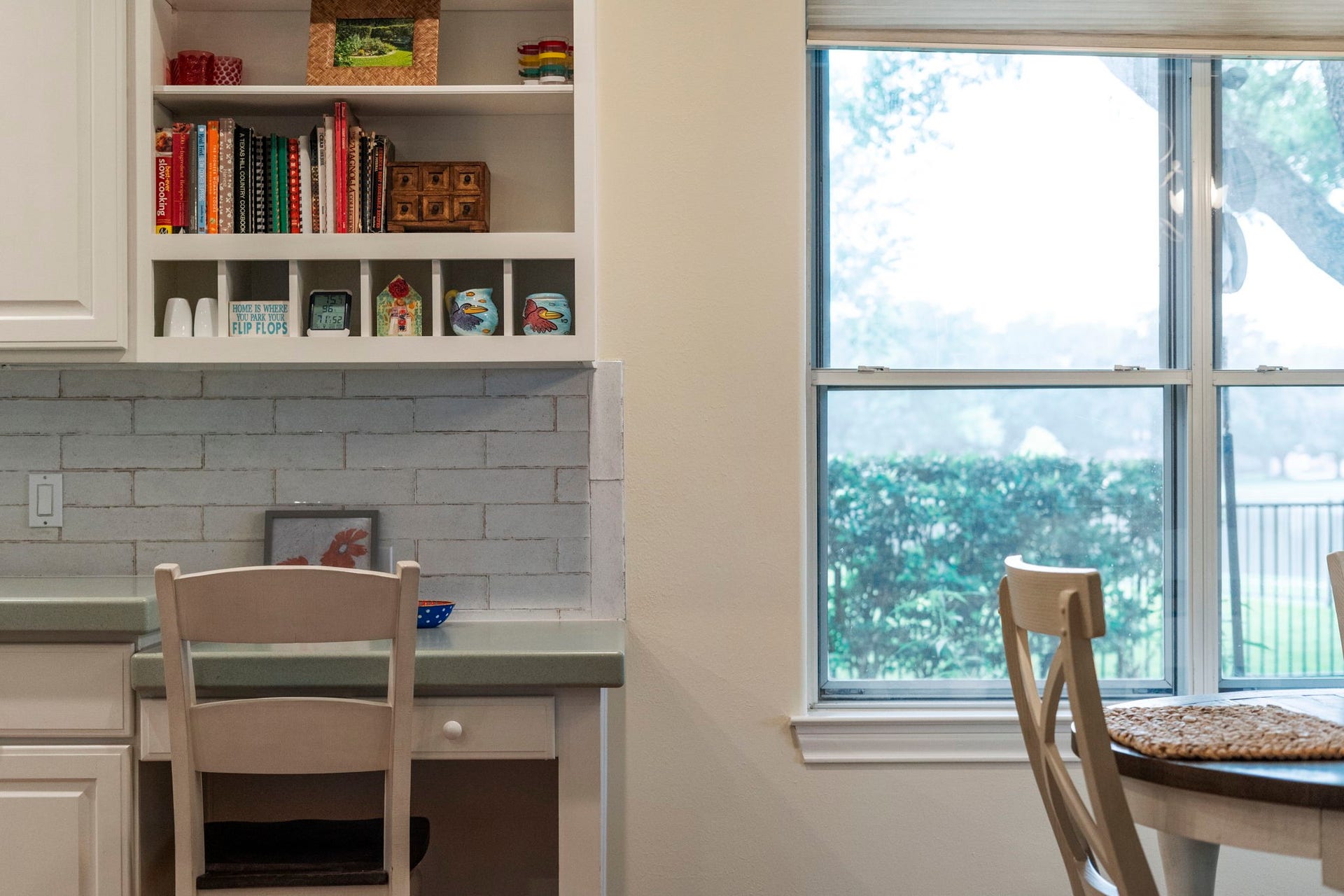 39 Rippling Creek Drive, Sugar Land, TX 77479 A built-in mini-office in the kitchen features a desk with a drawer, along with overhead shelves and cubbies for convenient organization.