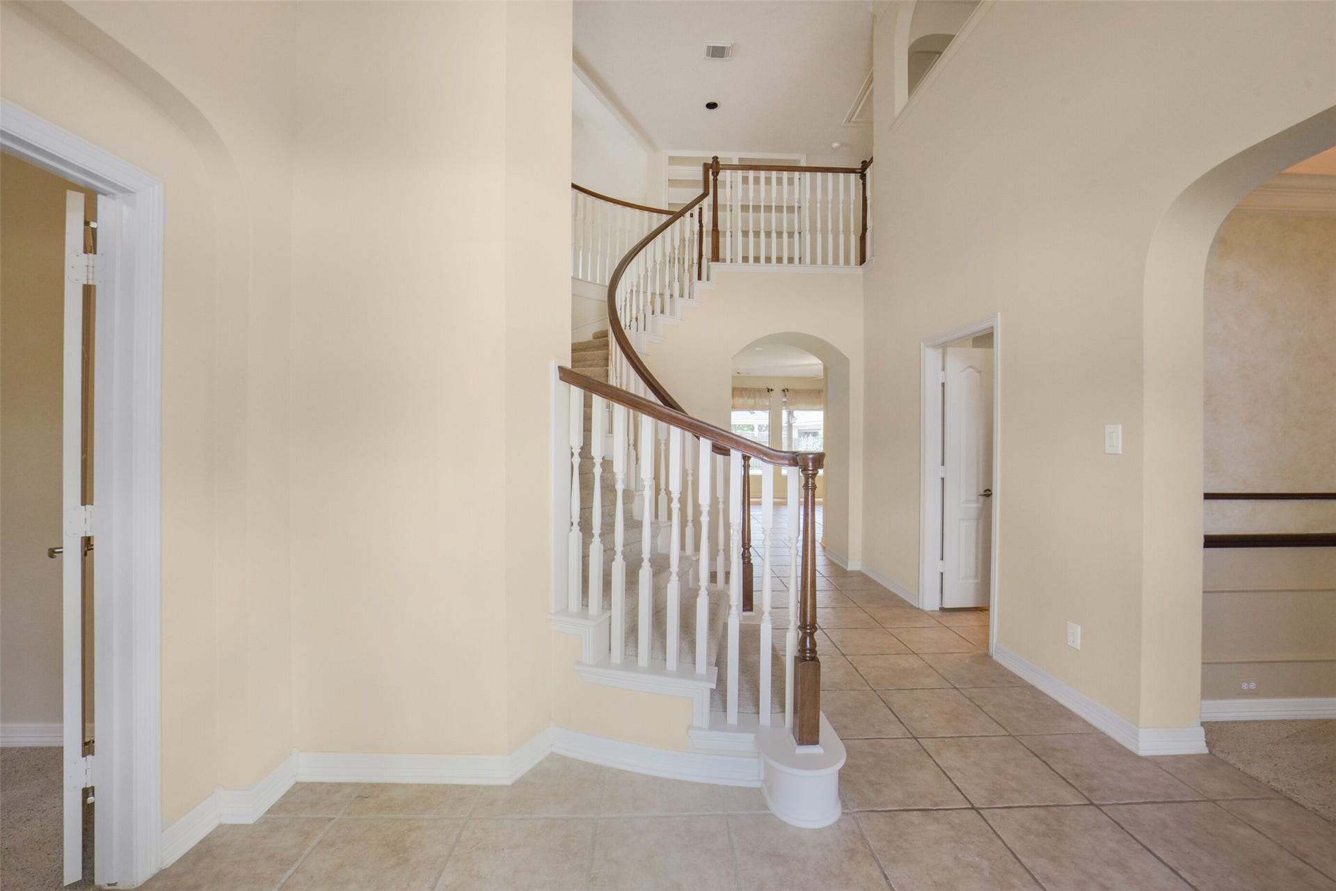 21603 Statfield Glen, Katy, TX 77450 Upon entering the two-story foyer, you'll find French doors to the left, opening into a study or formal living room. To the right, an elegant arched entryway leads to the formal dining room. The space is highlighted by a winding staircase, complete with wooden handrails and balusters.s.