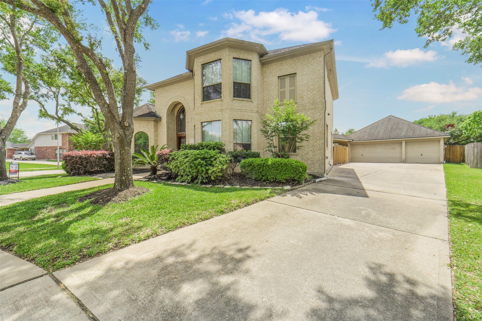 21603 Statfield Glen, Katy, TX 77450 This home is situated on a corner cul-de-sac lot with lush landscaping. It features a three-car detached garage and plenty of additional parking.