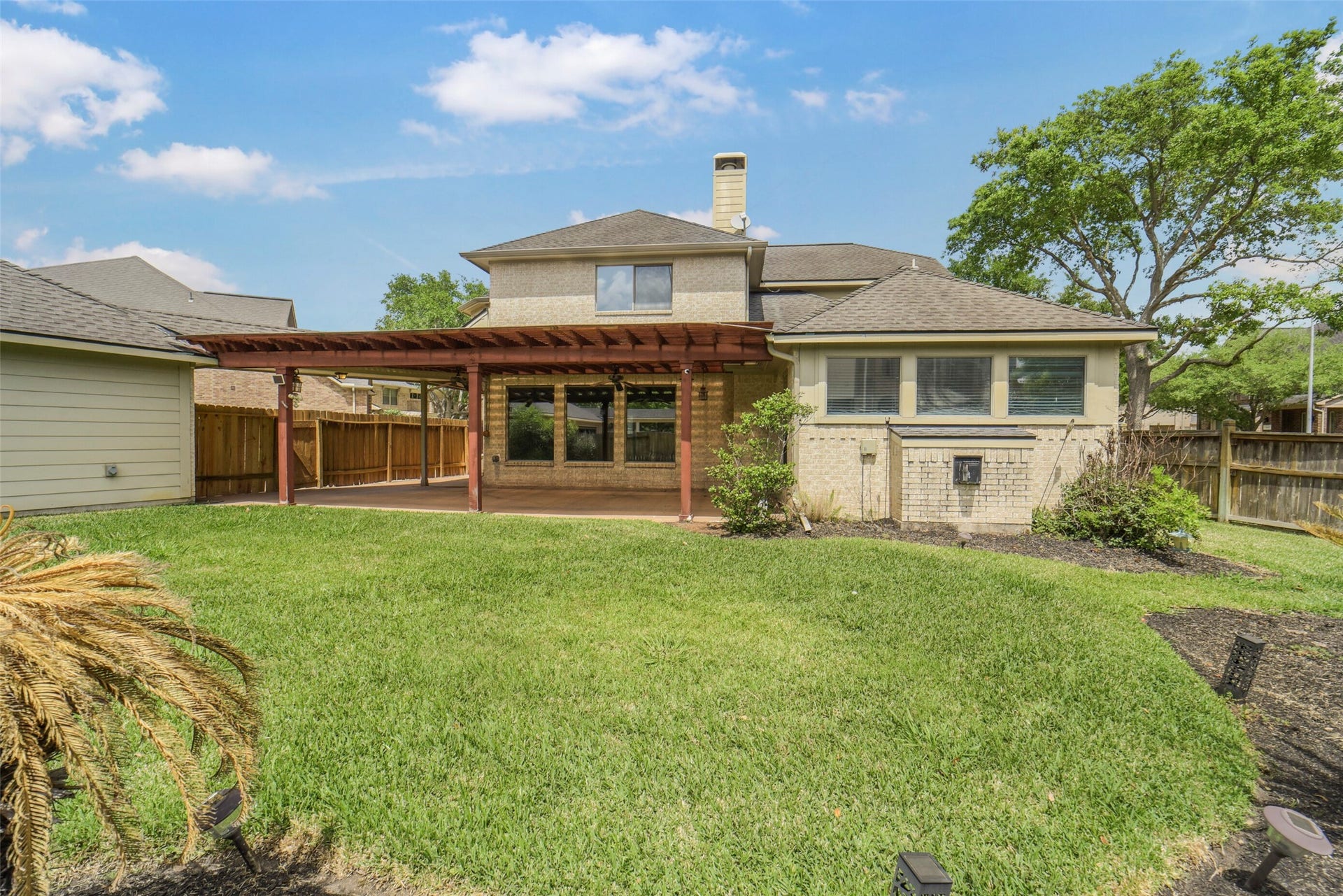 21603 Statfield Glen, Katy, TX 77450 The backyard features a large, covered patio and decking, ideal for entertaining.